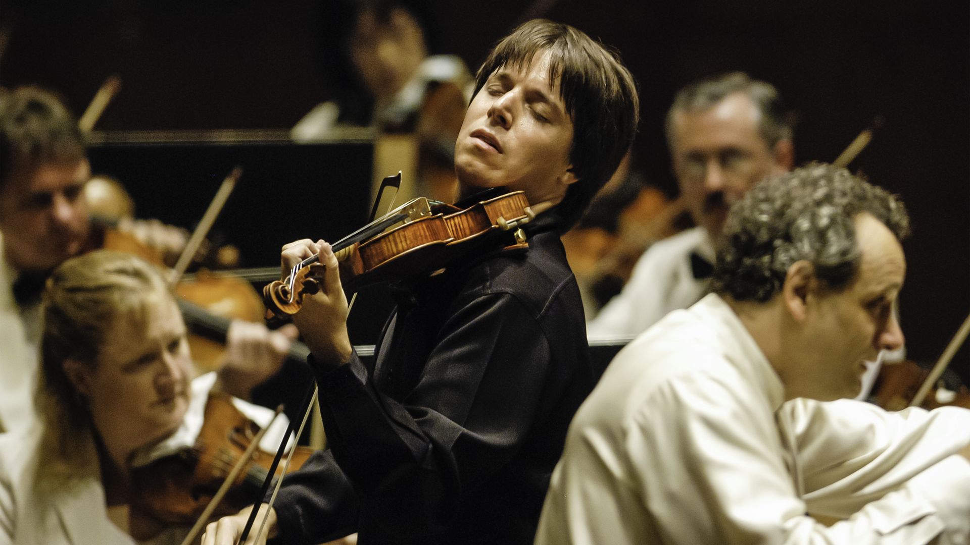Photo of a violinist playing in an orchestra 