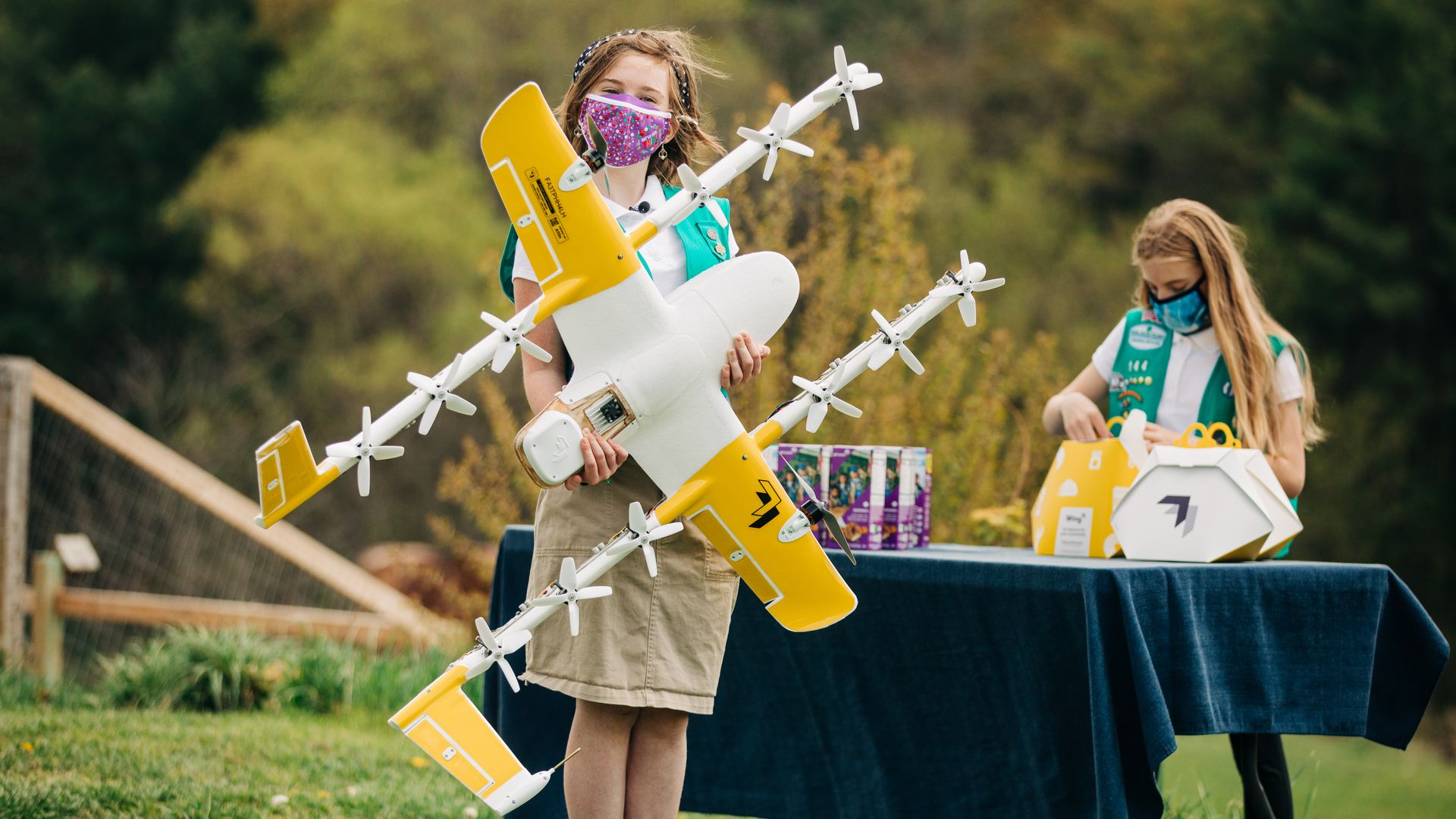 Two Virginia Girl Scouts prepare to send a cookie delivery via drone