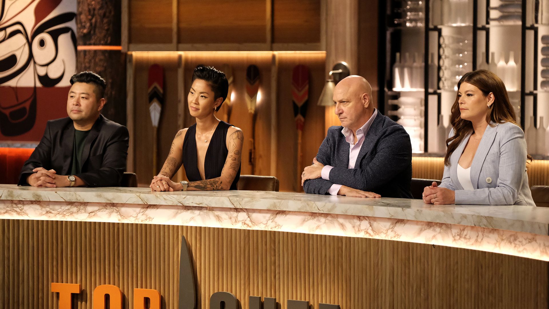 Four Top Chef judges sit at a table