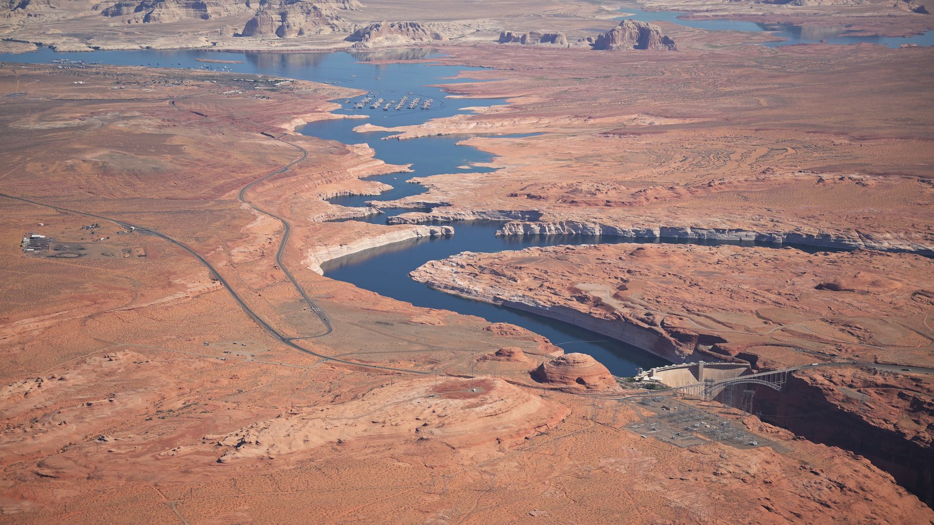 A beige, rocky desert landscape with no vegetation and a low river snaking through it.