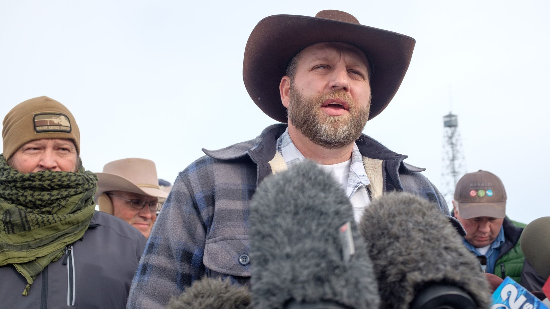 Photo of Ammon Bundy speaking into microphones
