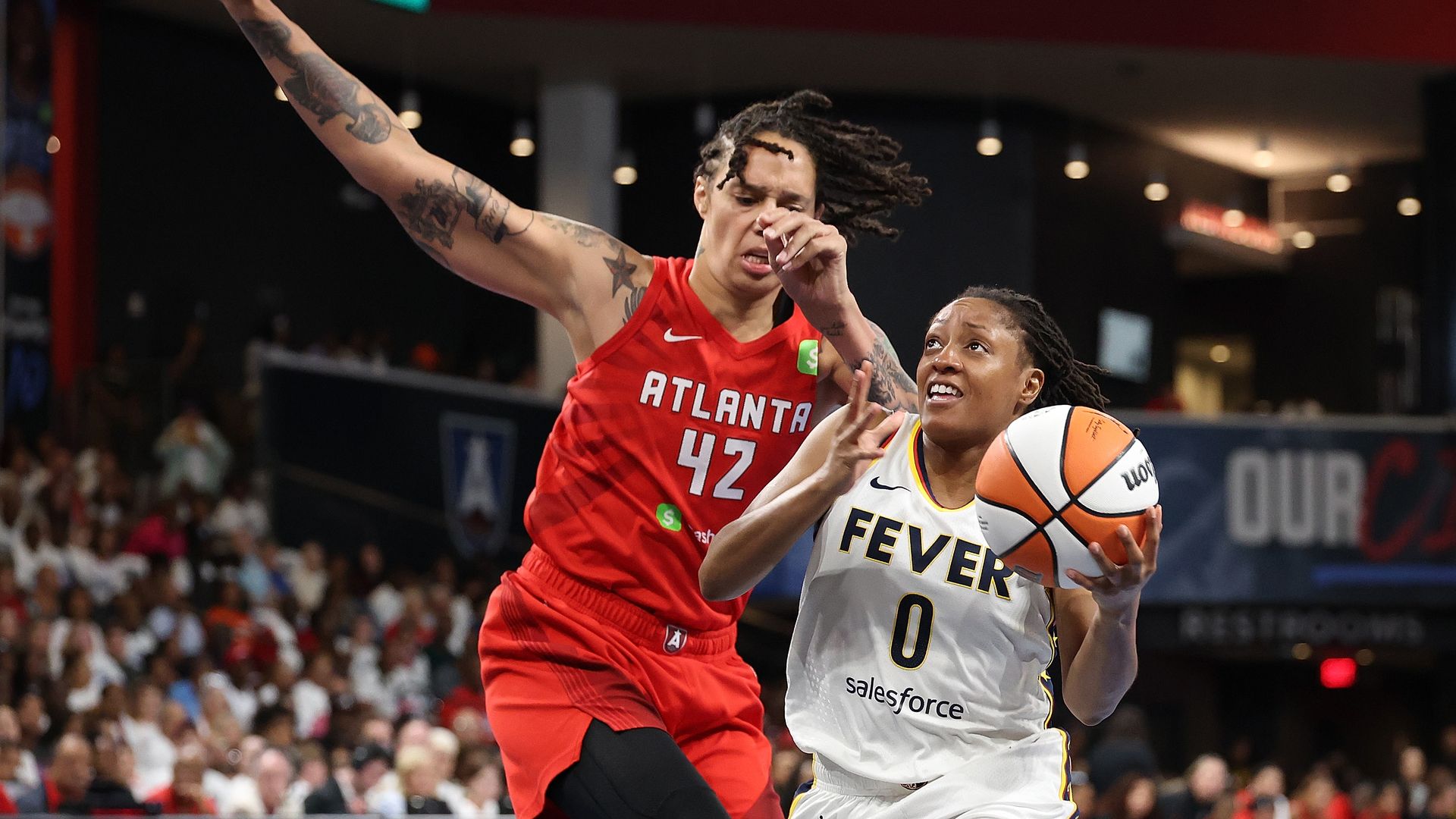 Kelsey Mitchell #0 of the Indiana Fever drives against Brittney Griner #42 of the Atlanta Dream during the first quarter of game one of the first round of WNBA Playoffs between the Indiana Fever and Atlanta Dream at Gateway Center Arena on September 14, 2025 in College Park, Georgia.