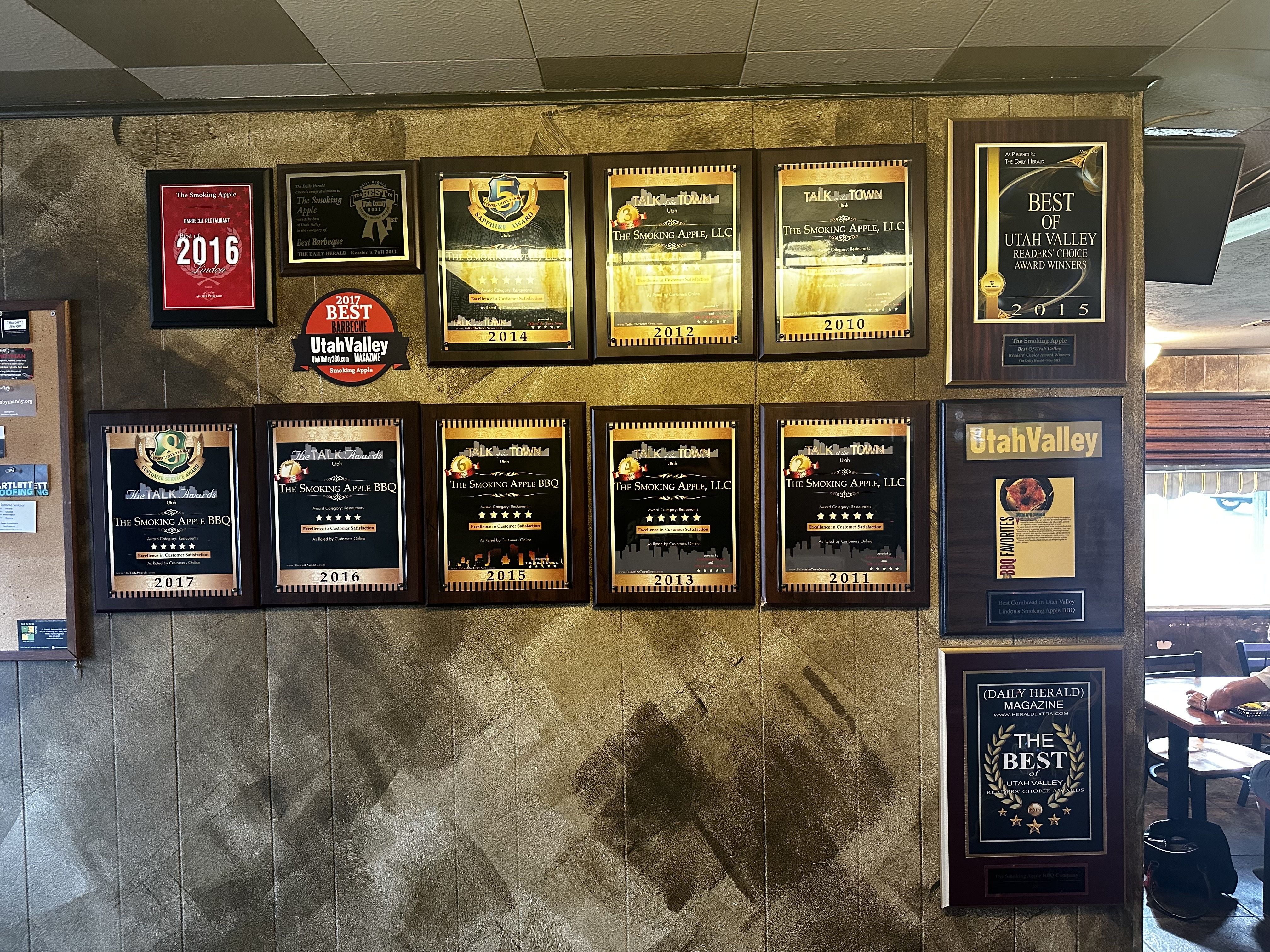 A wall featuring plaques and awards
