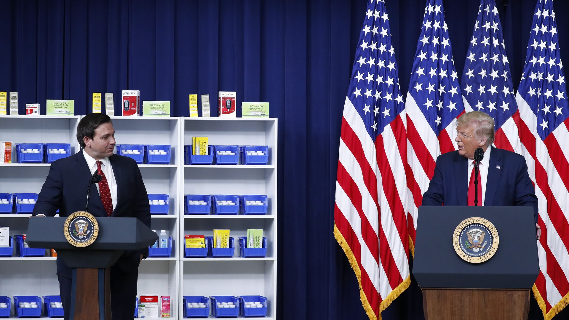 U.S. President Donald Trump, right, speaks to Governor Ron DeSantis, a Republican of Florida, during an executive order signing ceremony