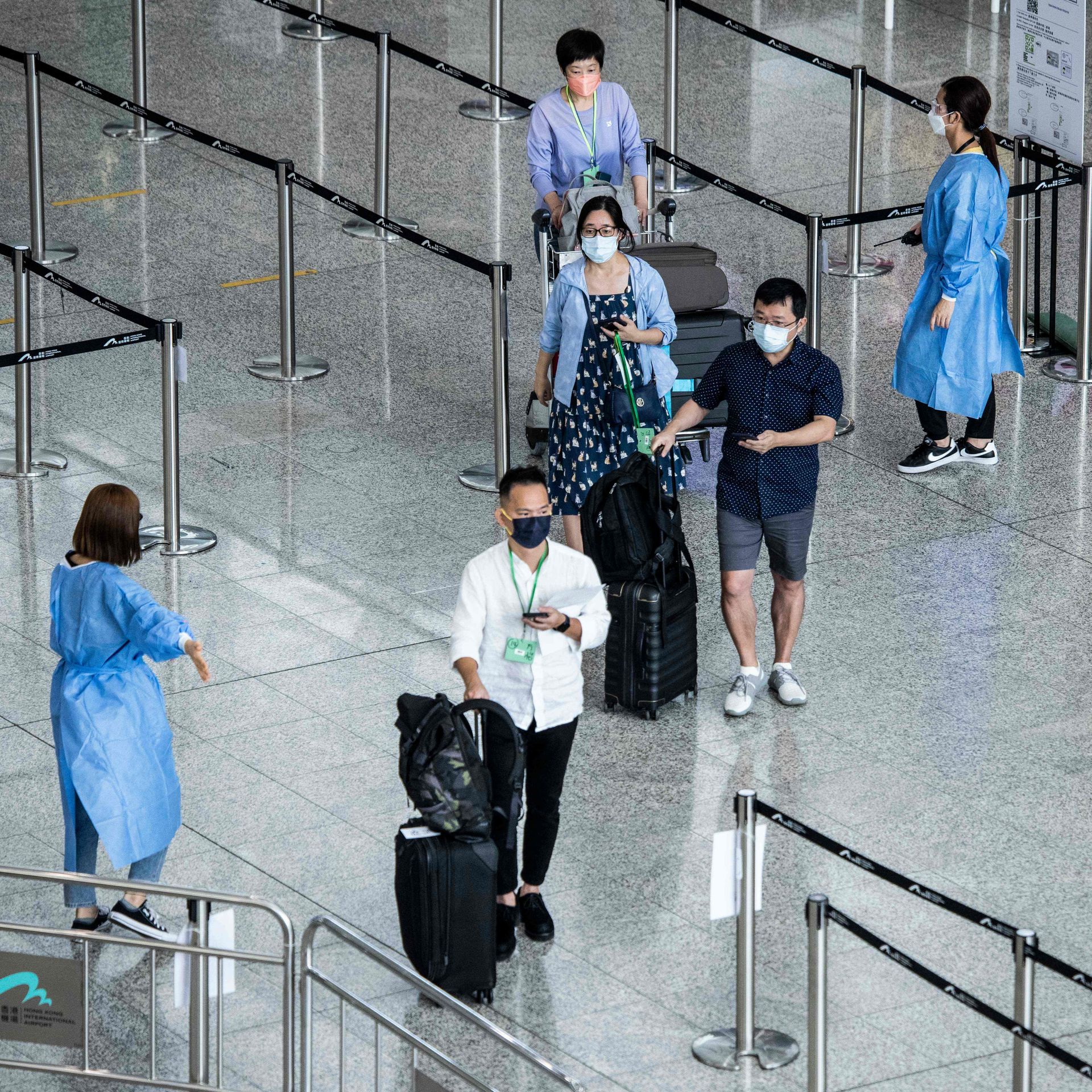 Travelers arrive at Hong Kong International Airport