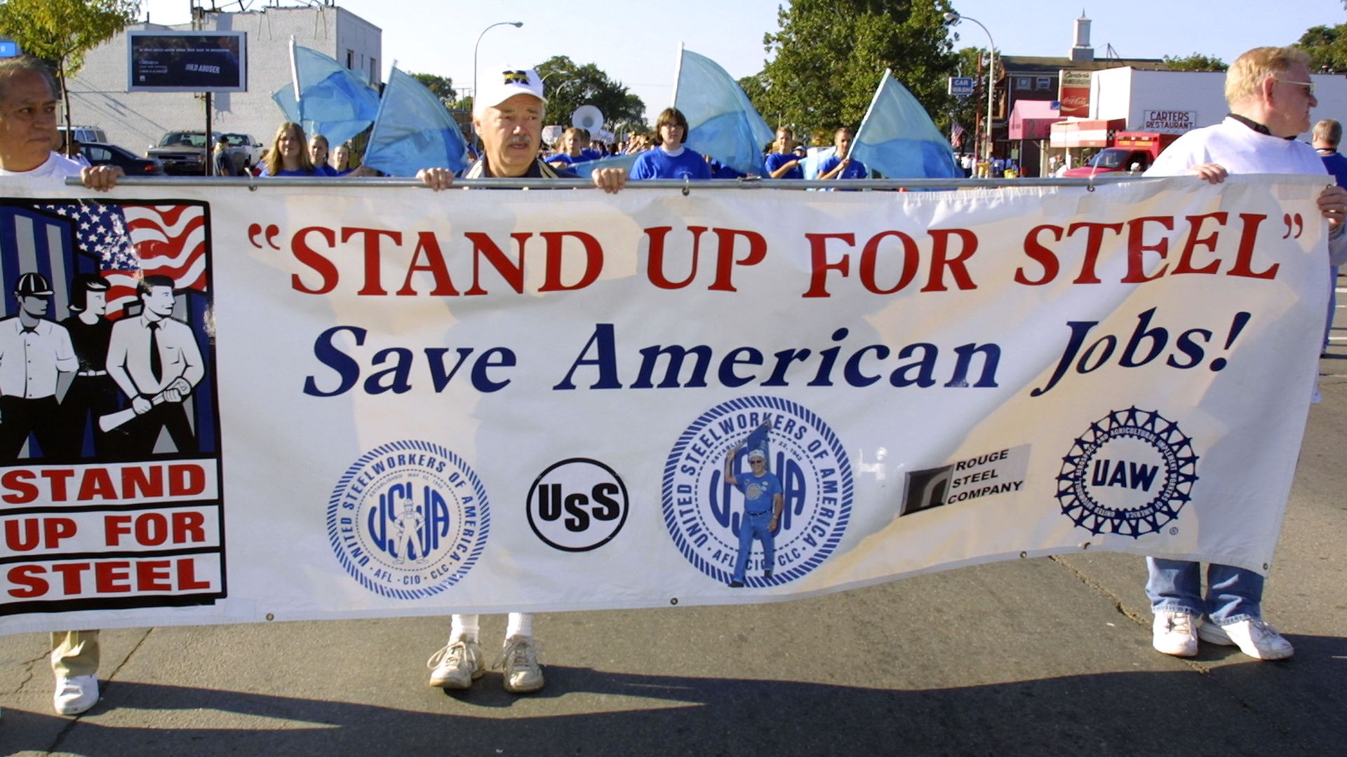 U.S. steel workers with sign that says save american steel