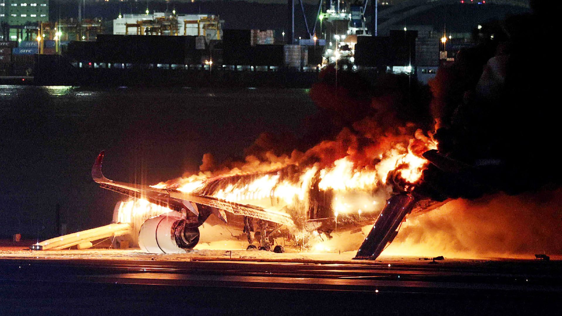 Japan Airlines Flight 516 on fire at Tokyo's Haneda Airport on January 2, 2024. Photo: STR/JIJI PRESS/AFP via Getty Images