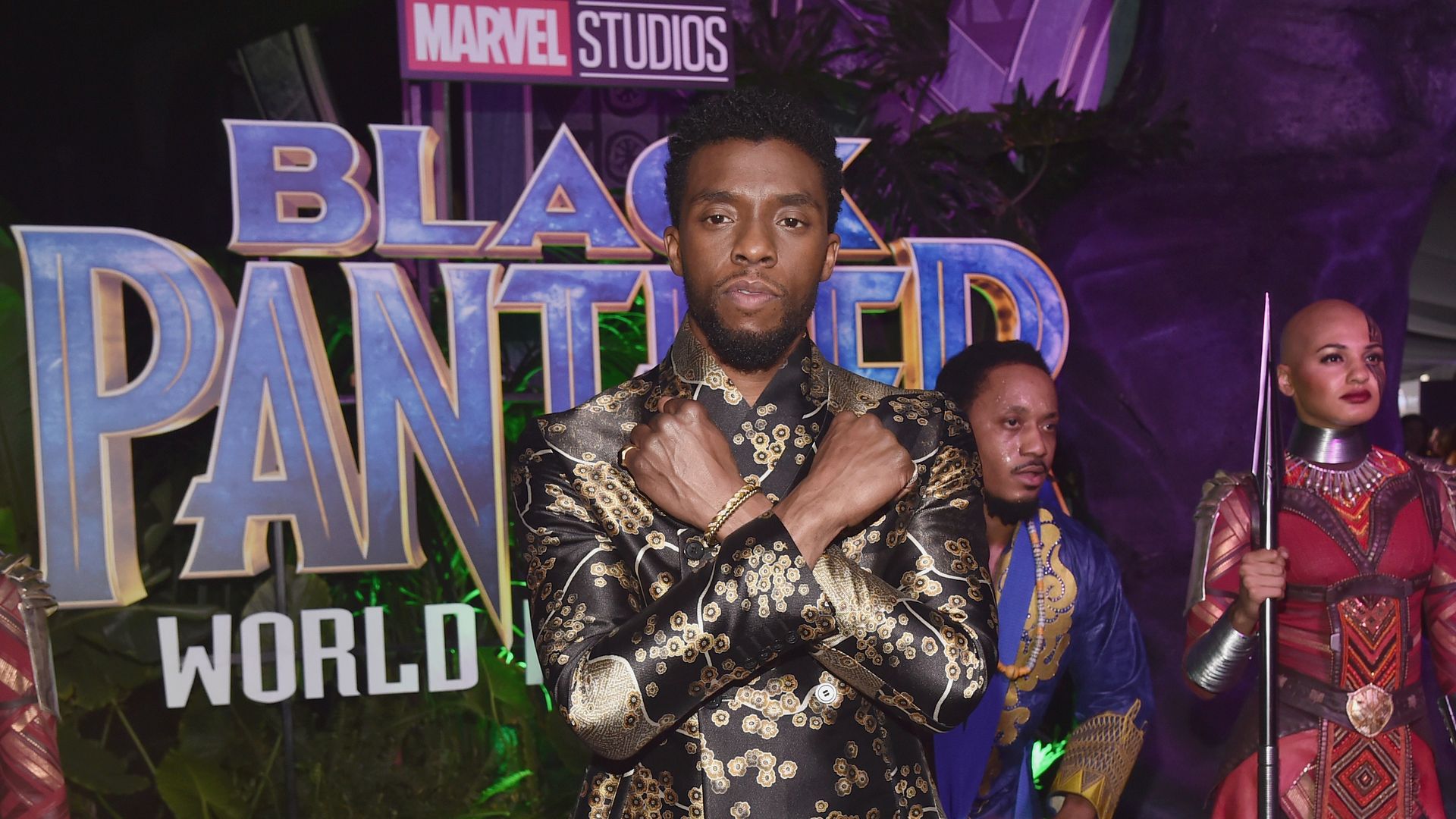 Actor Chadwick Boseman does the "Wakanda Forever" pose on the red carpet at a "Black Panther" premiere. 