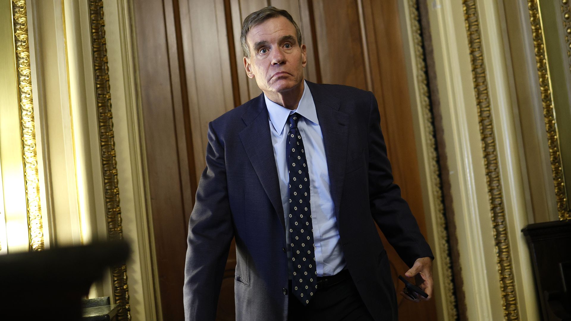 Sen. Mark Warner (D‑Va.) exits a Senate Democratic meeting at the U.S. Capitol, Oct. 3, 2025.