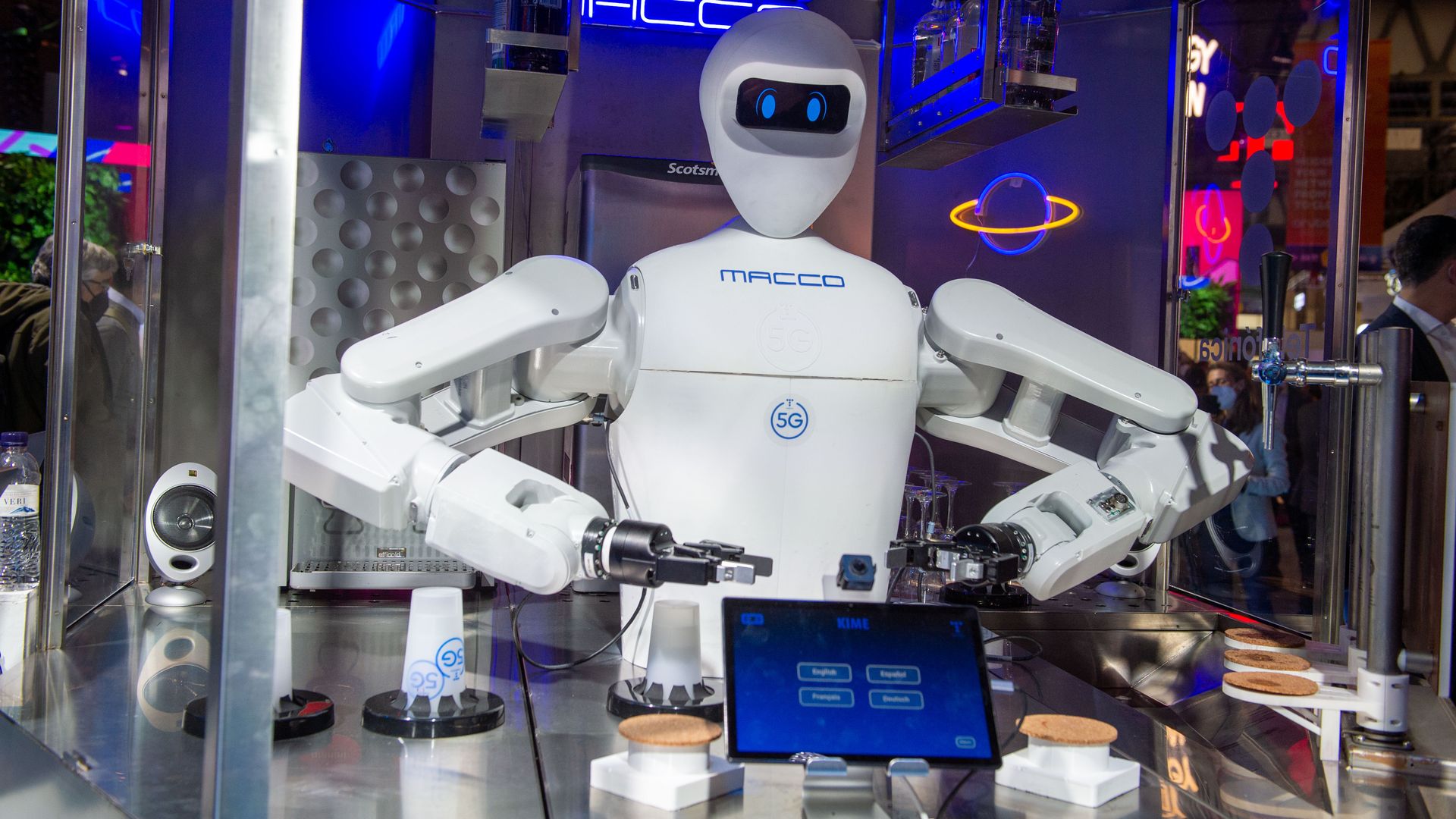 A robot bartender serves drinks at a trade conference