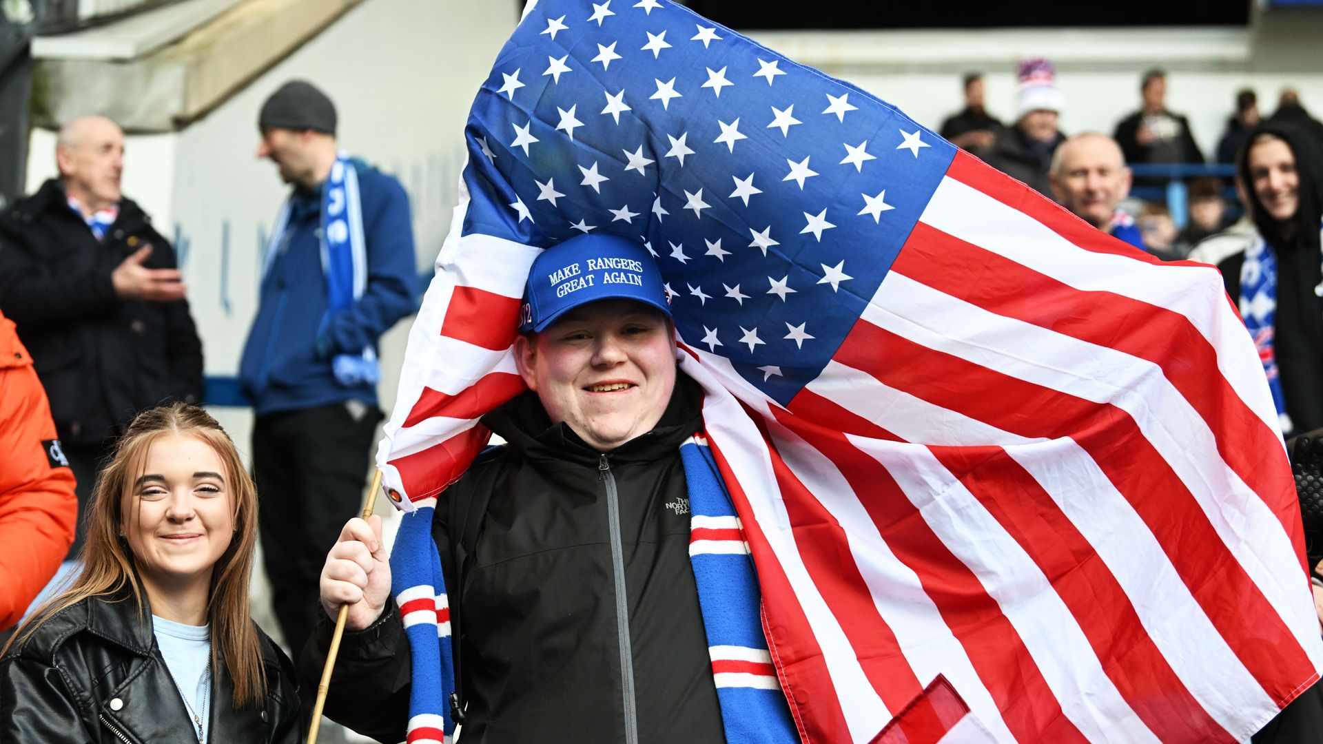 A Rangers fan wears a 'Make Rangers Great Again' hat following a prospective a takeover bid by 49ers Enterprises