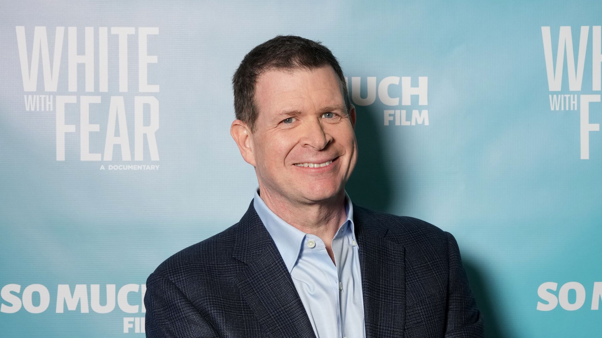 man in front of poster