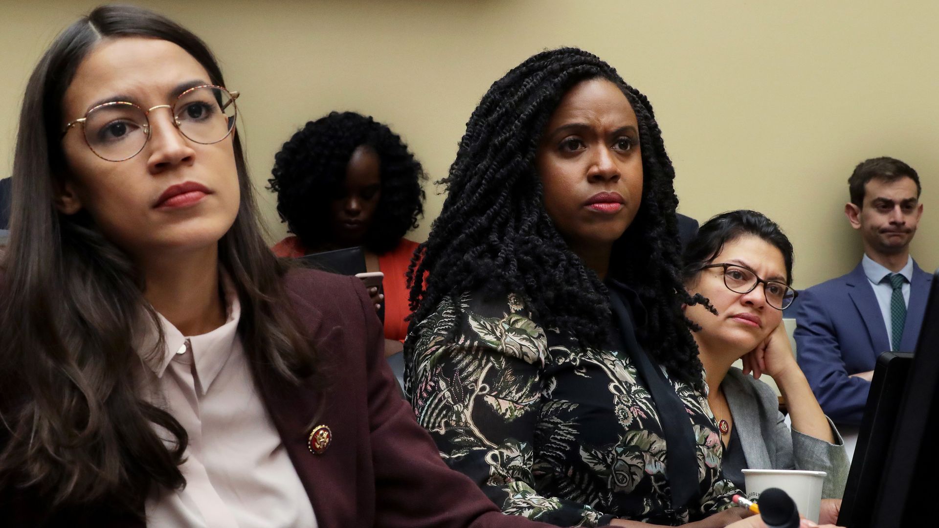 Three-fourths of The Squad are seen listening to testimony during a congressional hearing.