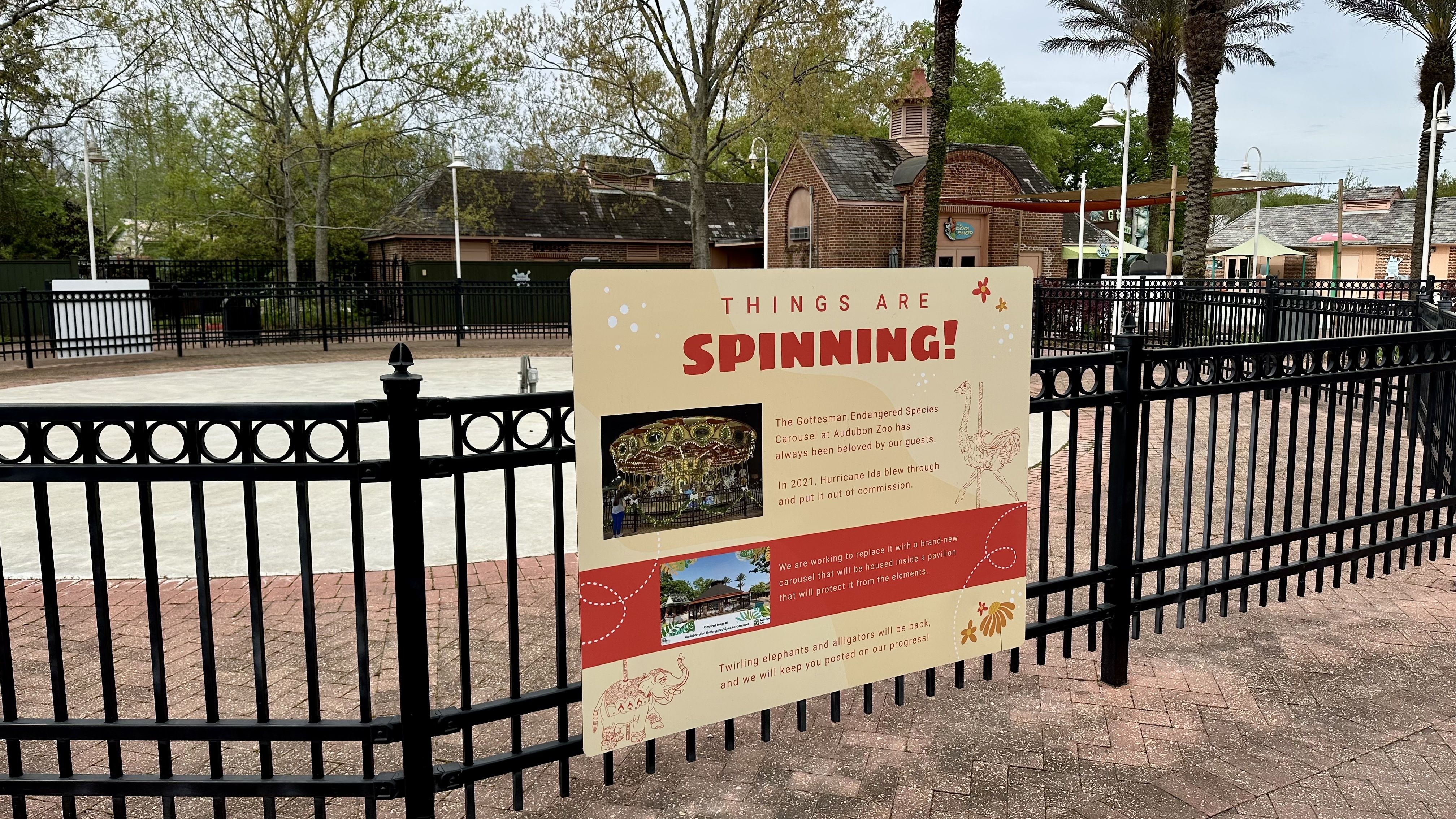 Image shows a photo of a fenced area with a sign.