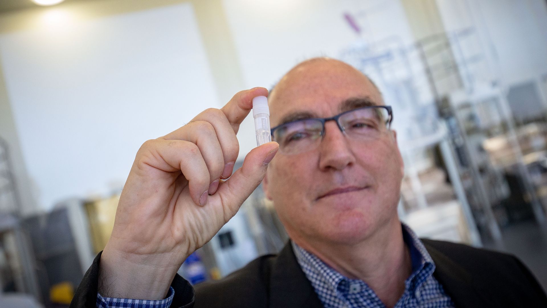 CSL’s Chief Scientific Officer, Dr Andrew Nash shows a small vial from the AstraZeneca vaccine. 