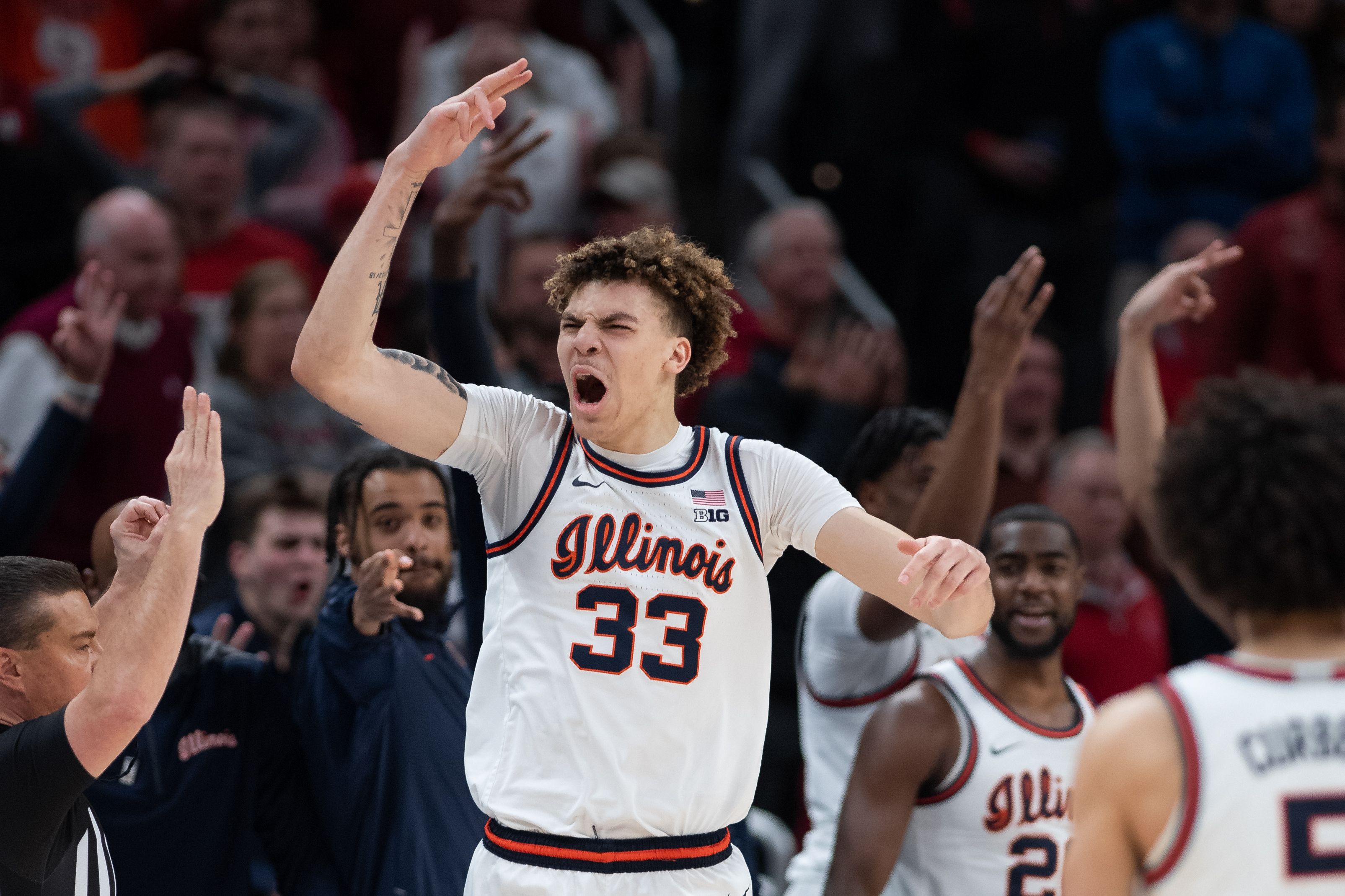 Photo of a man celebrating in a basketball uniform.