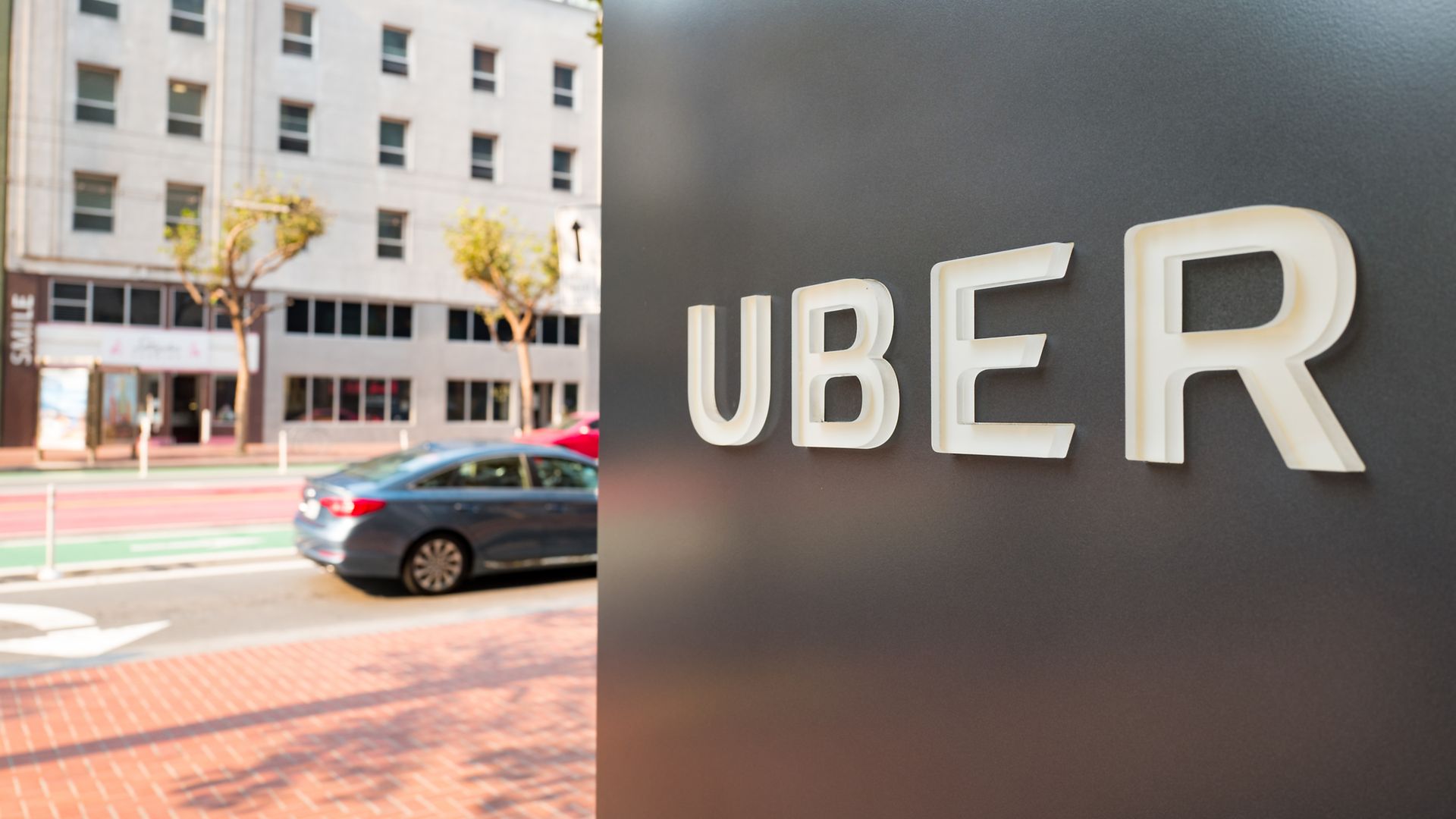 Sign with logo at the headquarters of ride-sharing technology company Uber in San Francisco, California