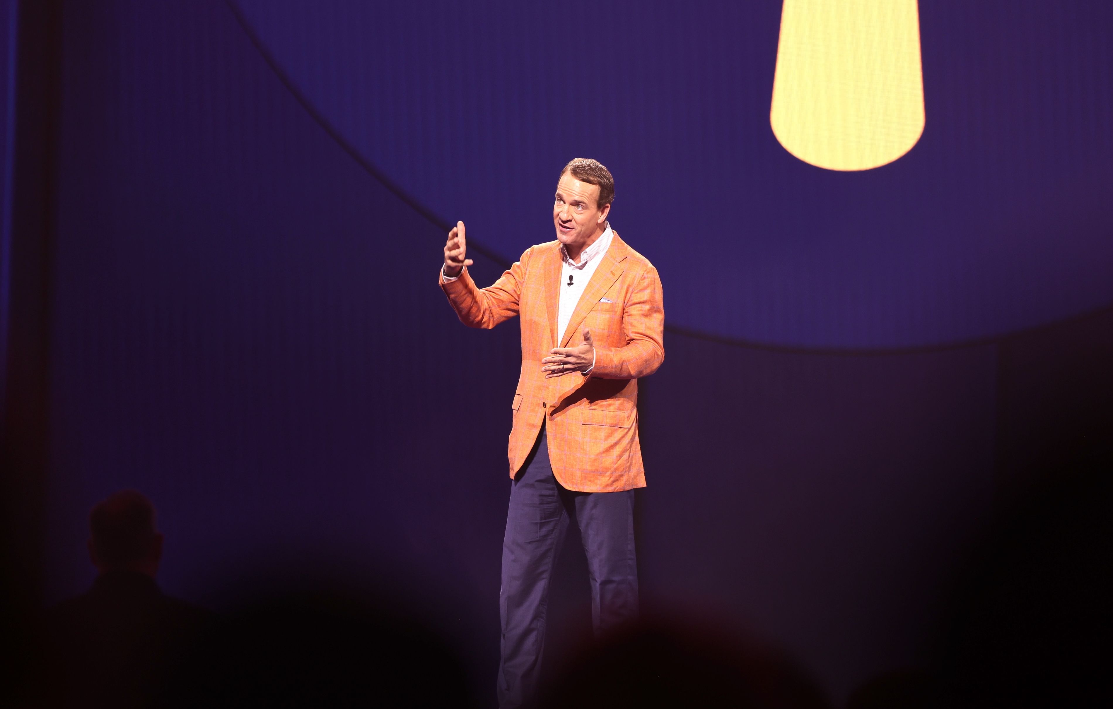 Peyton Manning emcees the Walmart associate's meeting. 