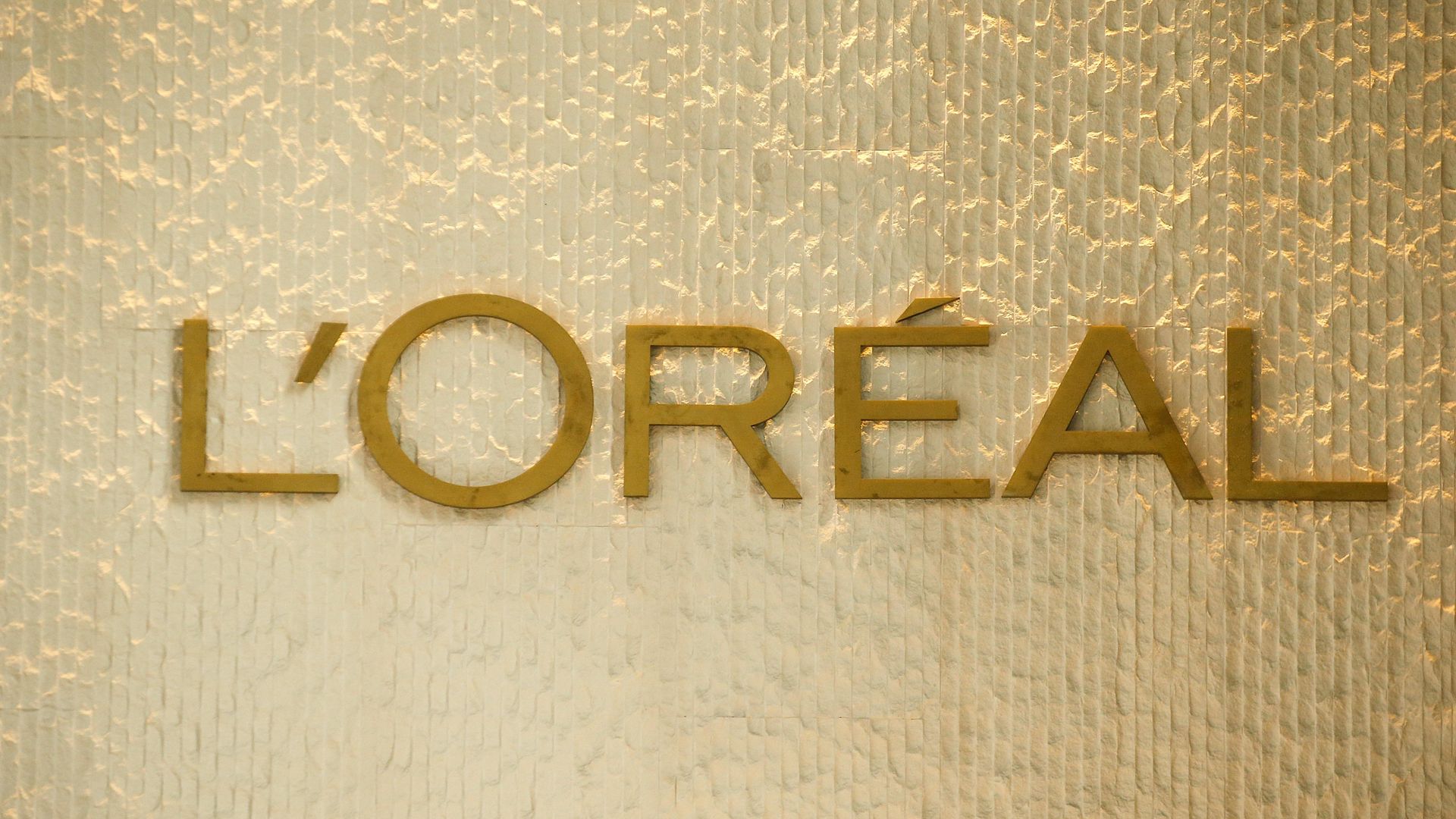 The L'Oreal label in gold on a light gold wall