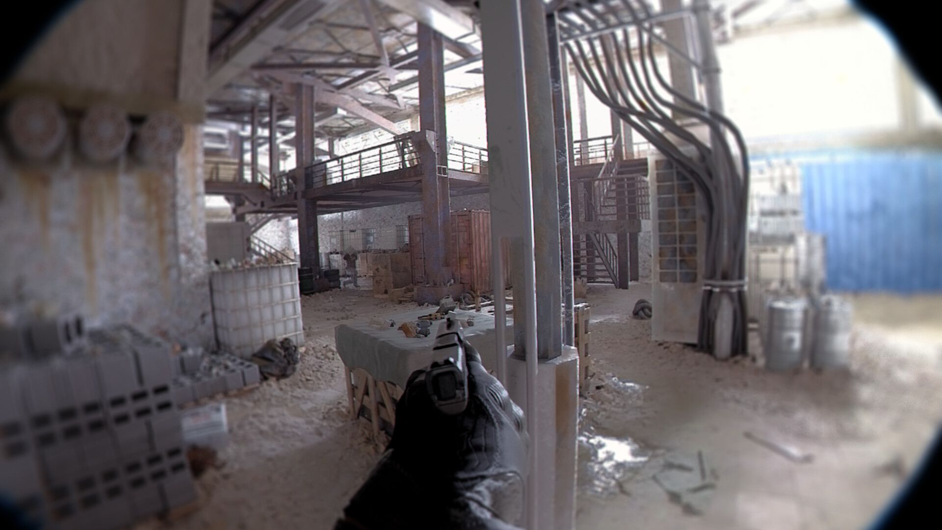 Video game screenshot showing the first-person perspective of a person aiming a handgun in a warehouse