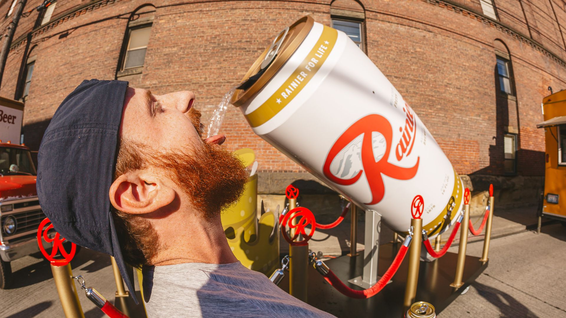 A person drinks from a gigantic can of Rainier beer at last year's all-day beerfest in Seattle. 