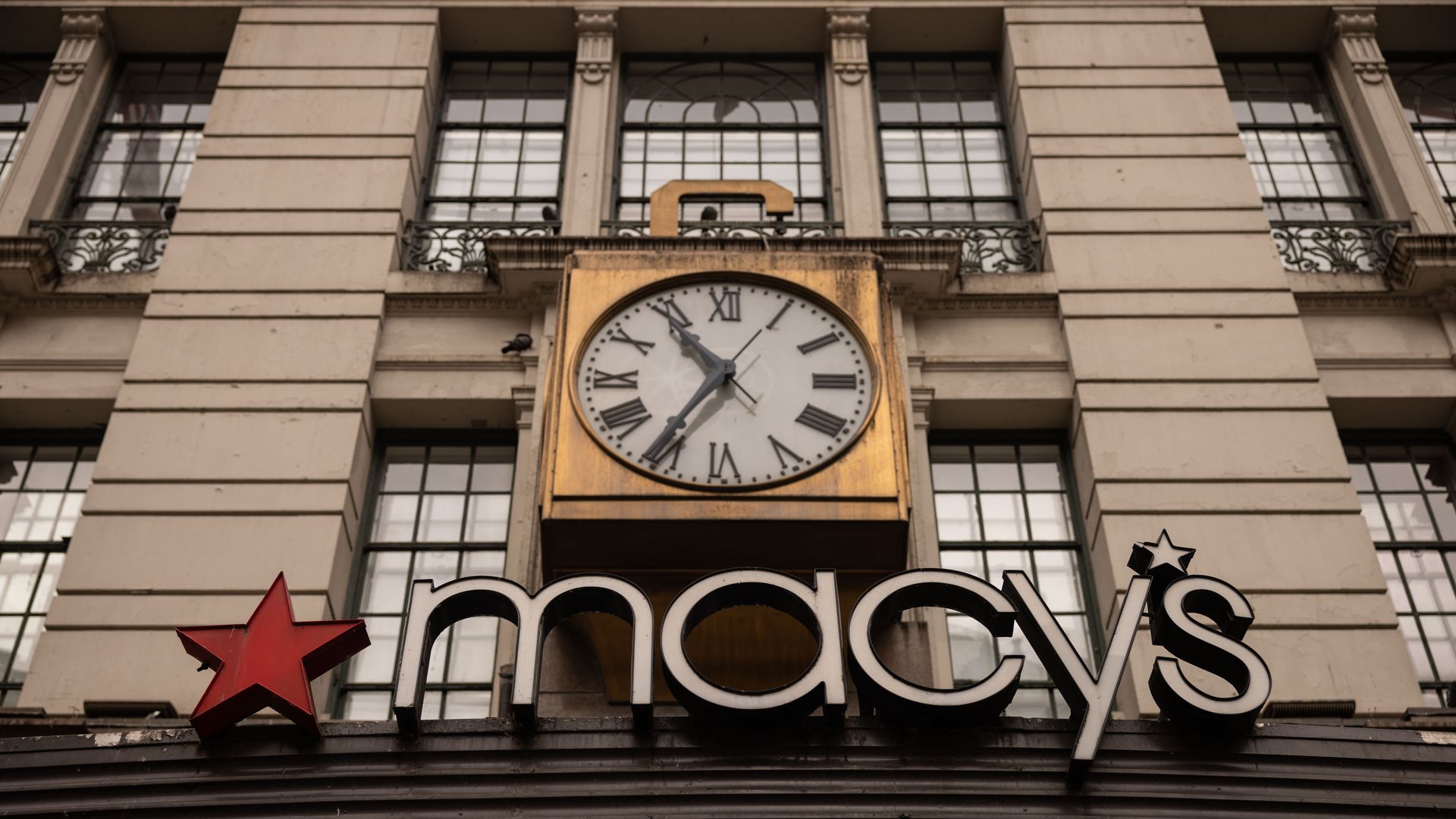 Photo of Macy's storefrong including large gold clock 