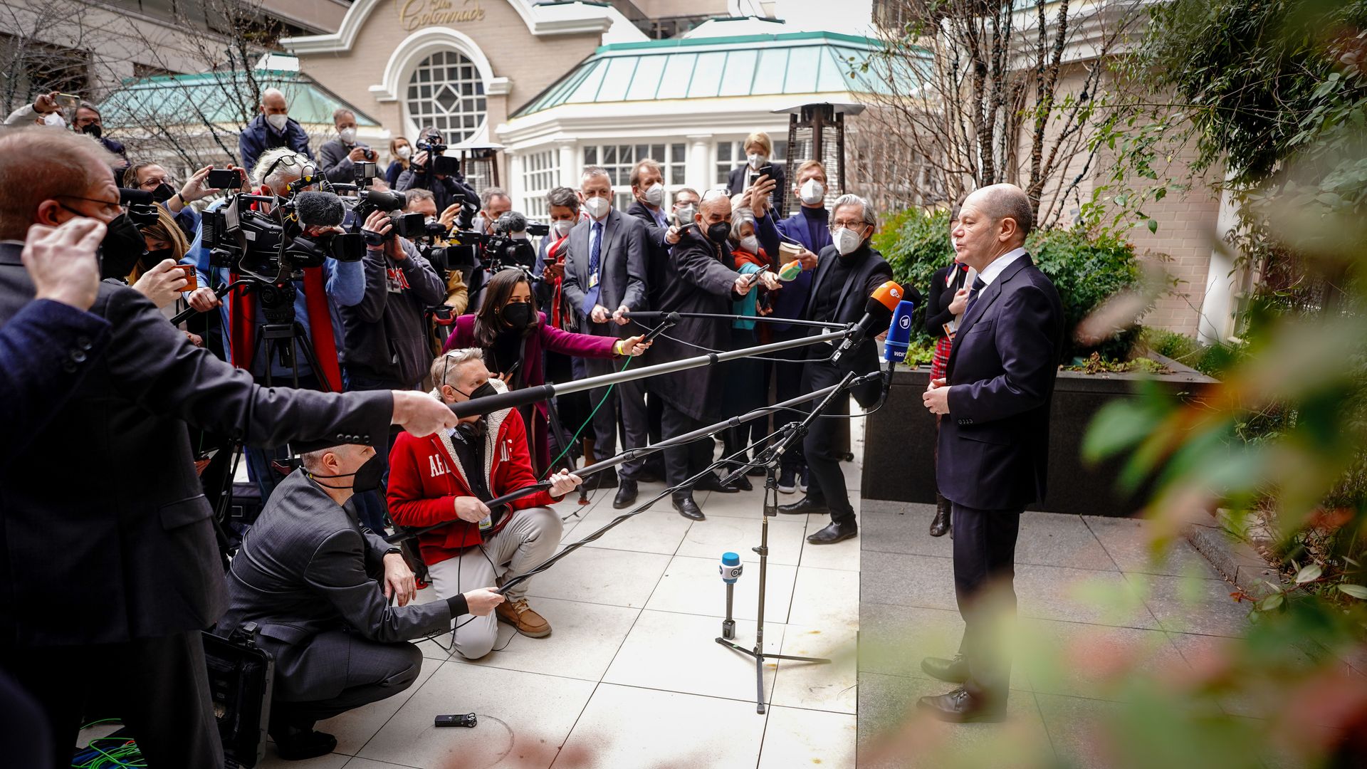 German Chancellor Olaf Scholz is seen addressing his traveling media before a meeting in Washington with President Biden.