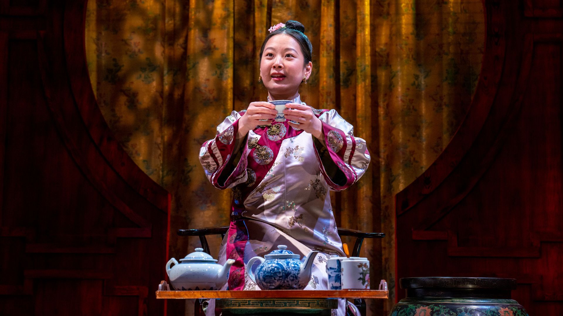 A production still of a actor in a theater scene.