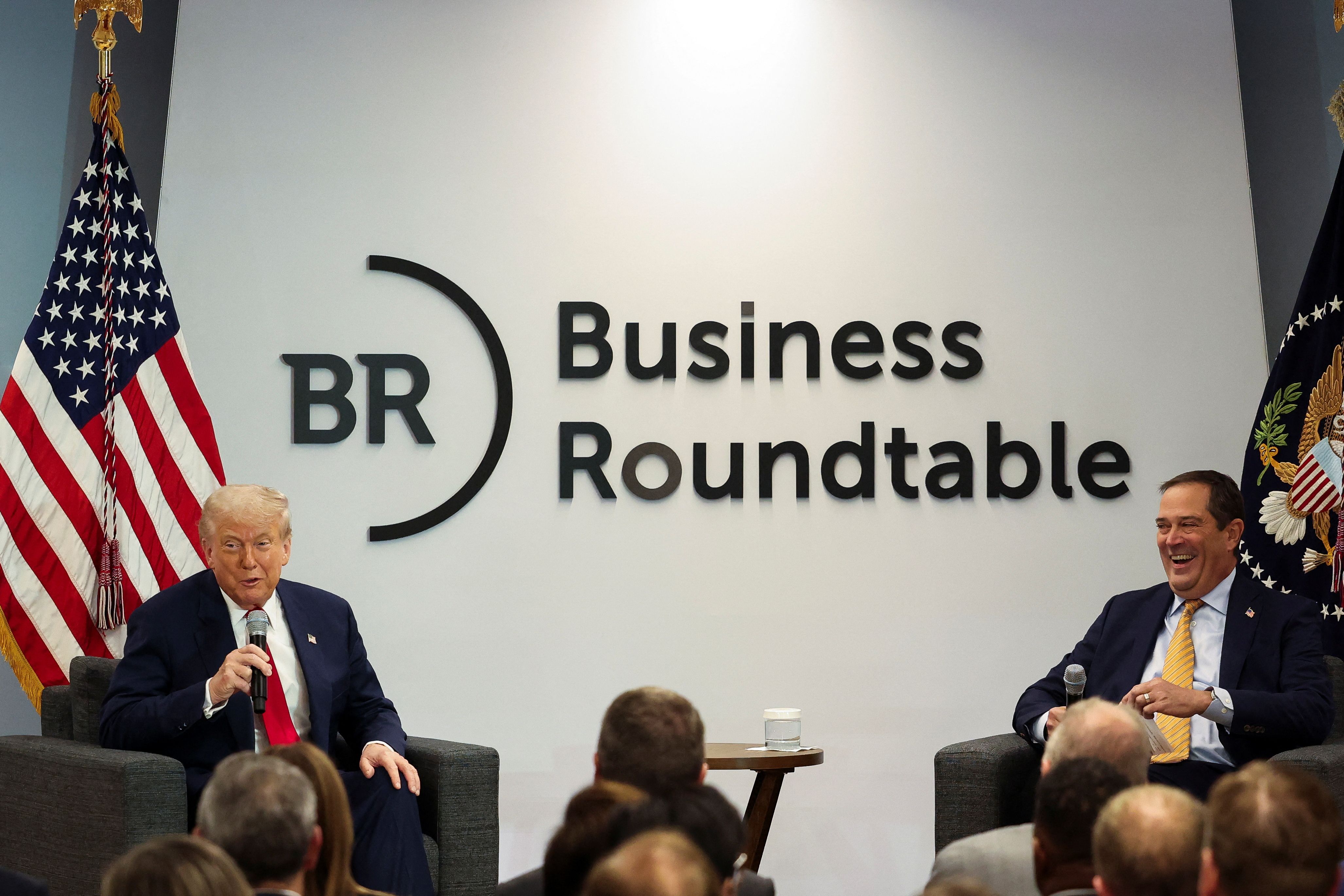 President Trump talks with Chuck Robbins, Cisco CEO and Business Roundtable chair, at The Wharf in D.C. on Tuesday.