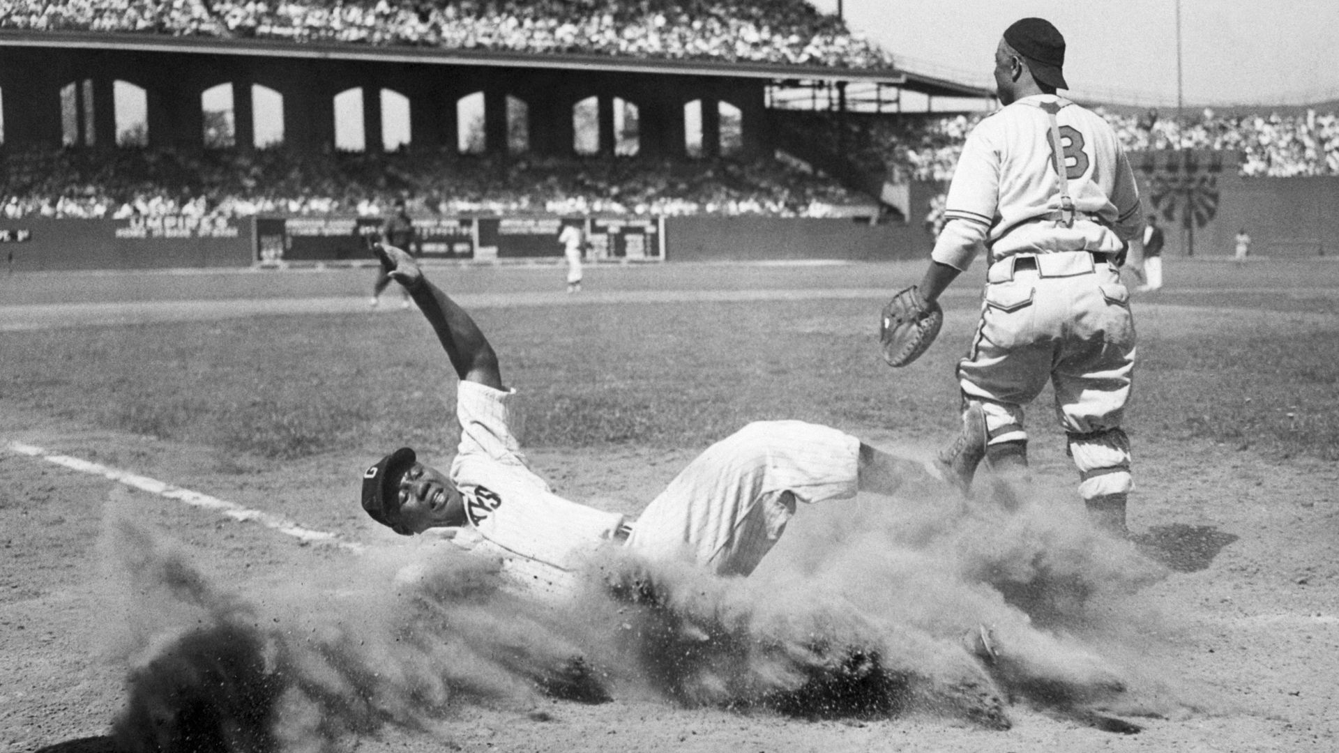Josh Gibson slides into home during the 1944 East-West All-Star Game of the Negro Leagues at Chicago's Comiskey Park.