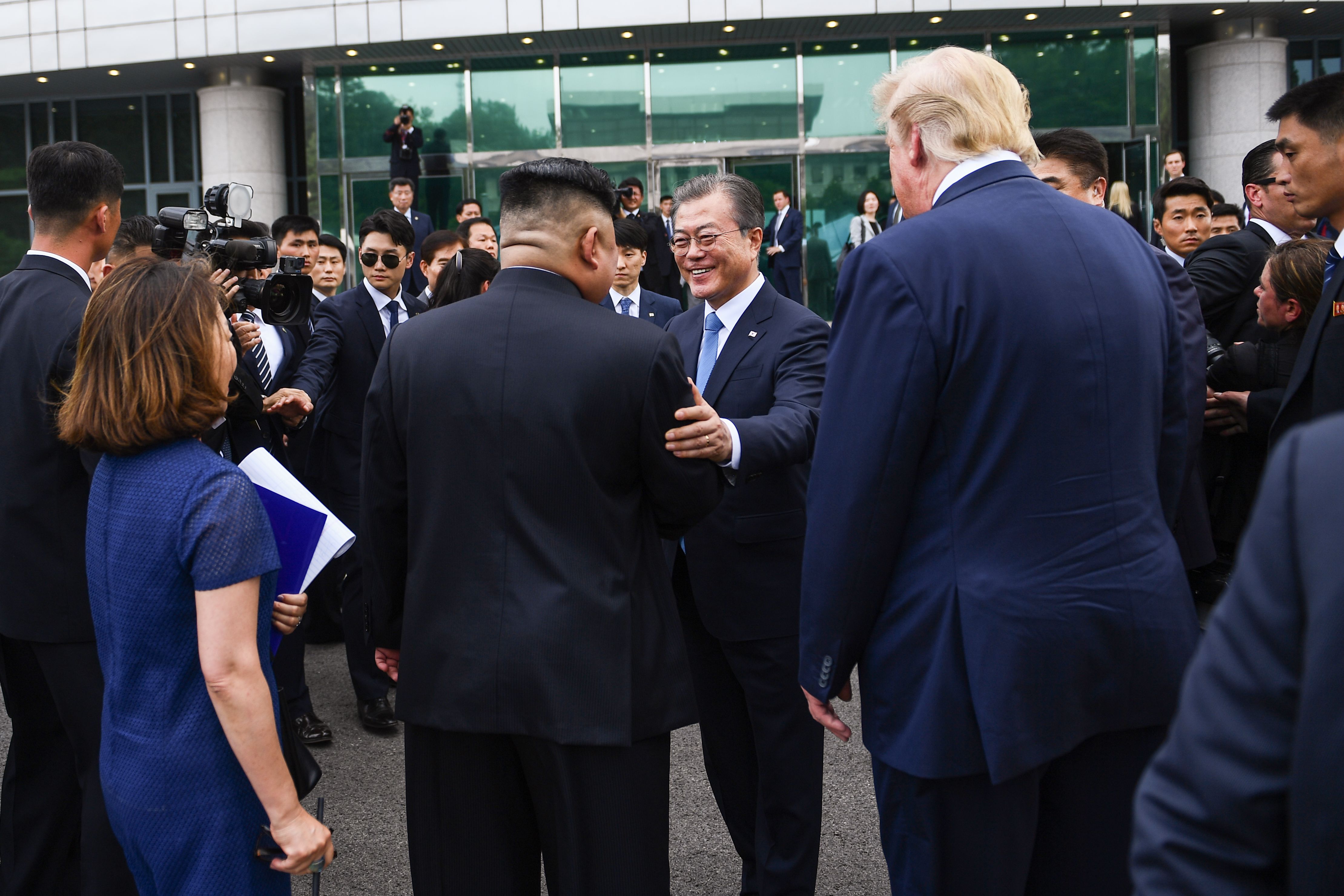  North Korea's leader Kim Jong Un (centre L) meets with South Korea's President Moon Jae-in (C) as US President Donald Trump (centre R) looks on at the DMZ.