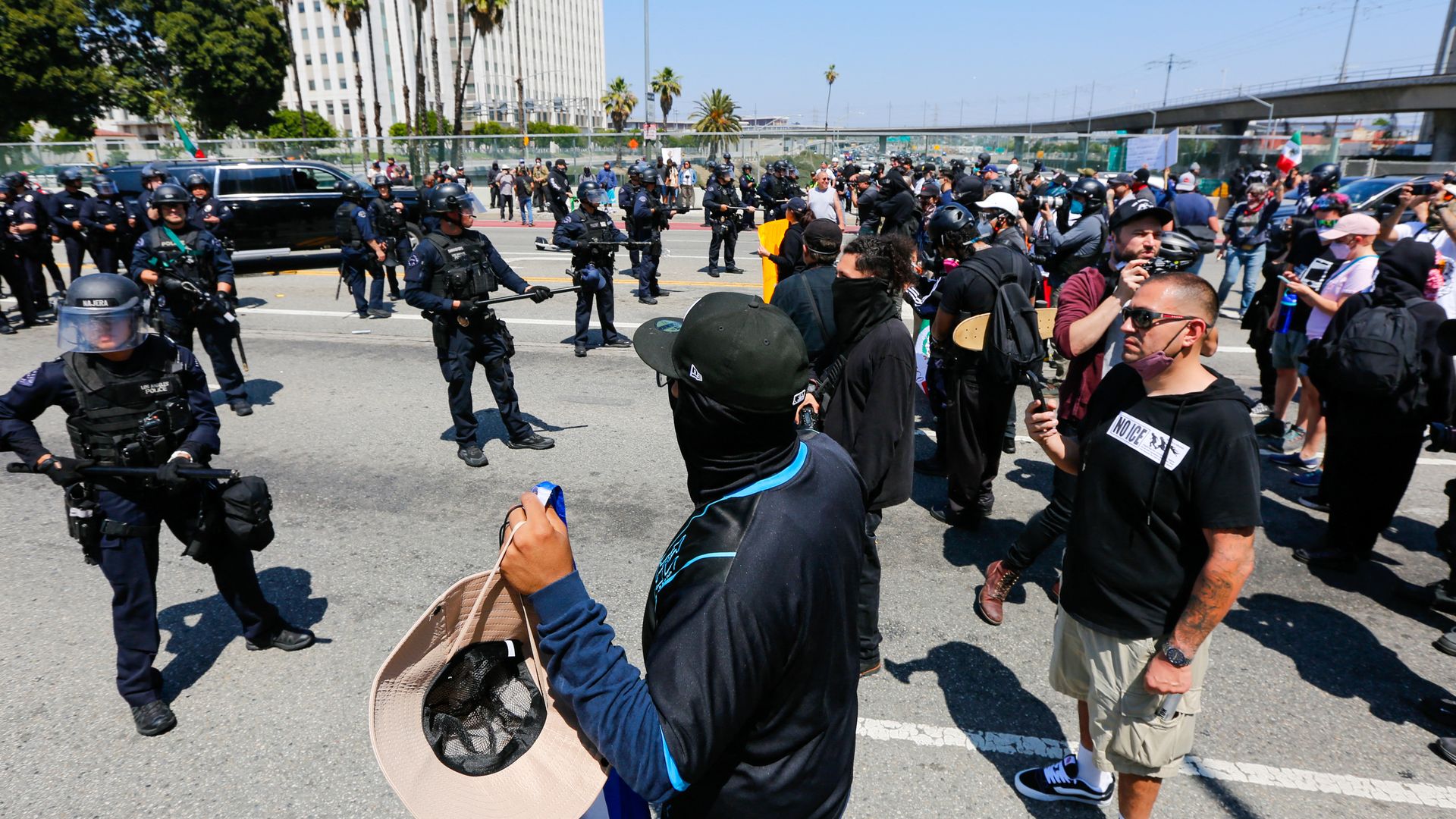 Protesters face off with LAPD officers during an anti-ICE protest in Downtown Los Angeles, California, on June 8, 2025. The demonstration was sparked by a series of ICE raids that began on June 7. (Photo by Benjamin Hanson / Middle East Images via AFP) (Photo by BENJAMIN HANSON/Middle East Images/AF