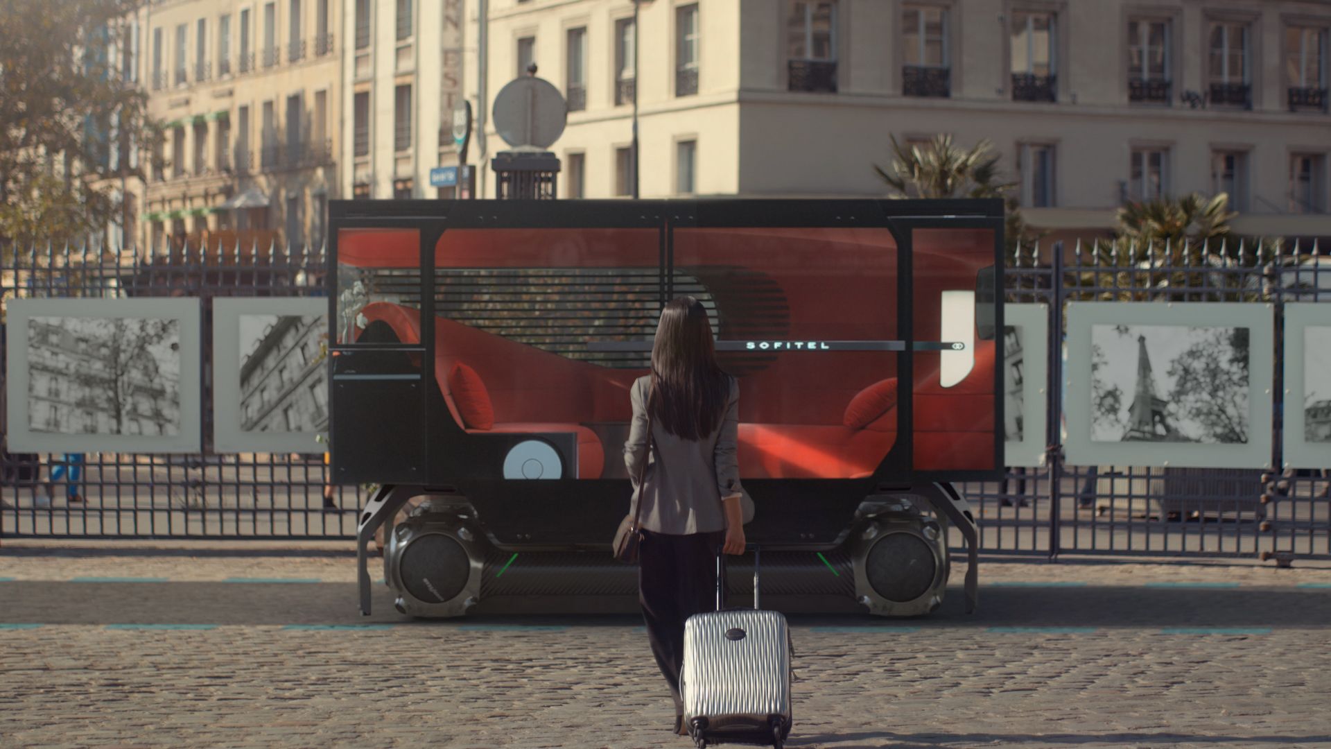 A woman with luggage approaching the Citroen En Voyage concept for an autonomous hotel lounge on wheels.