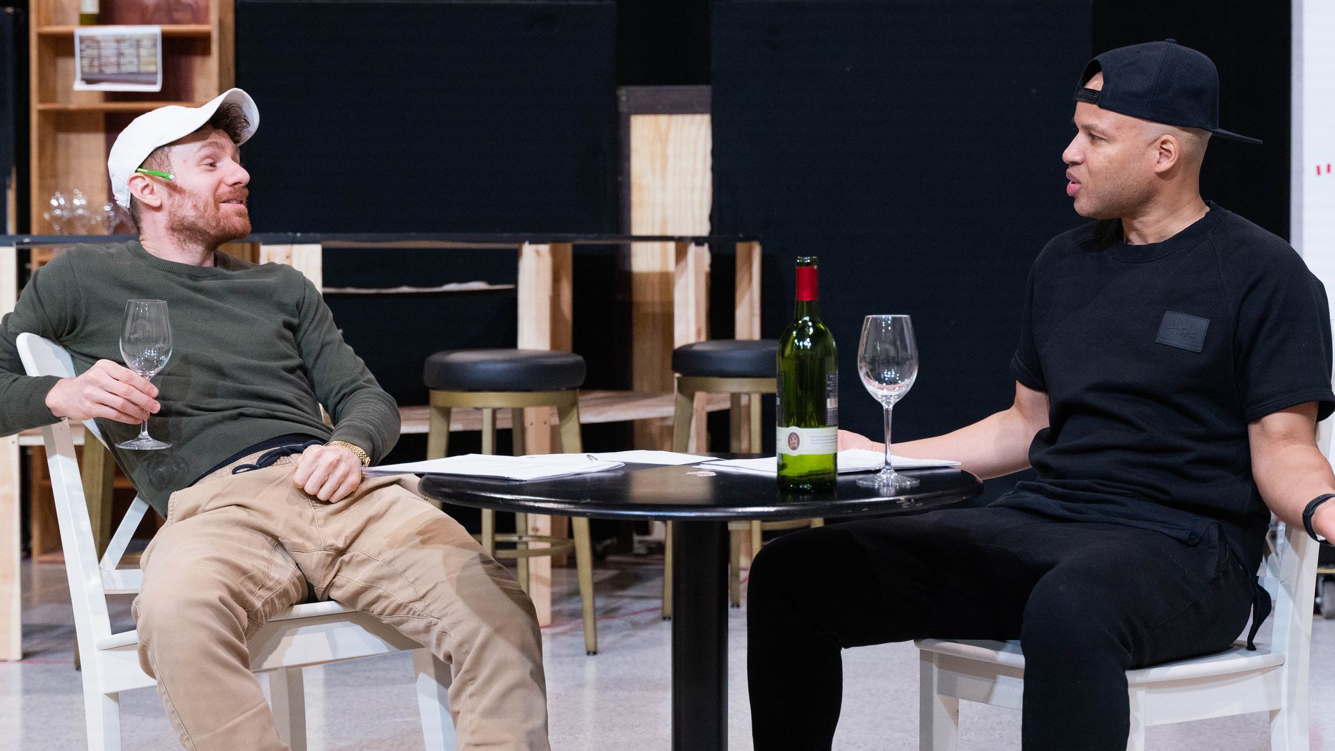 Two guys talking at a table