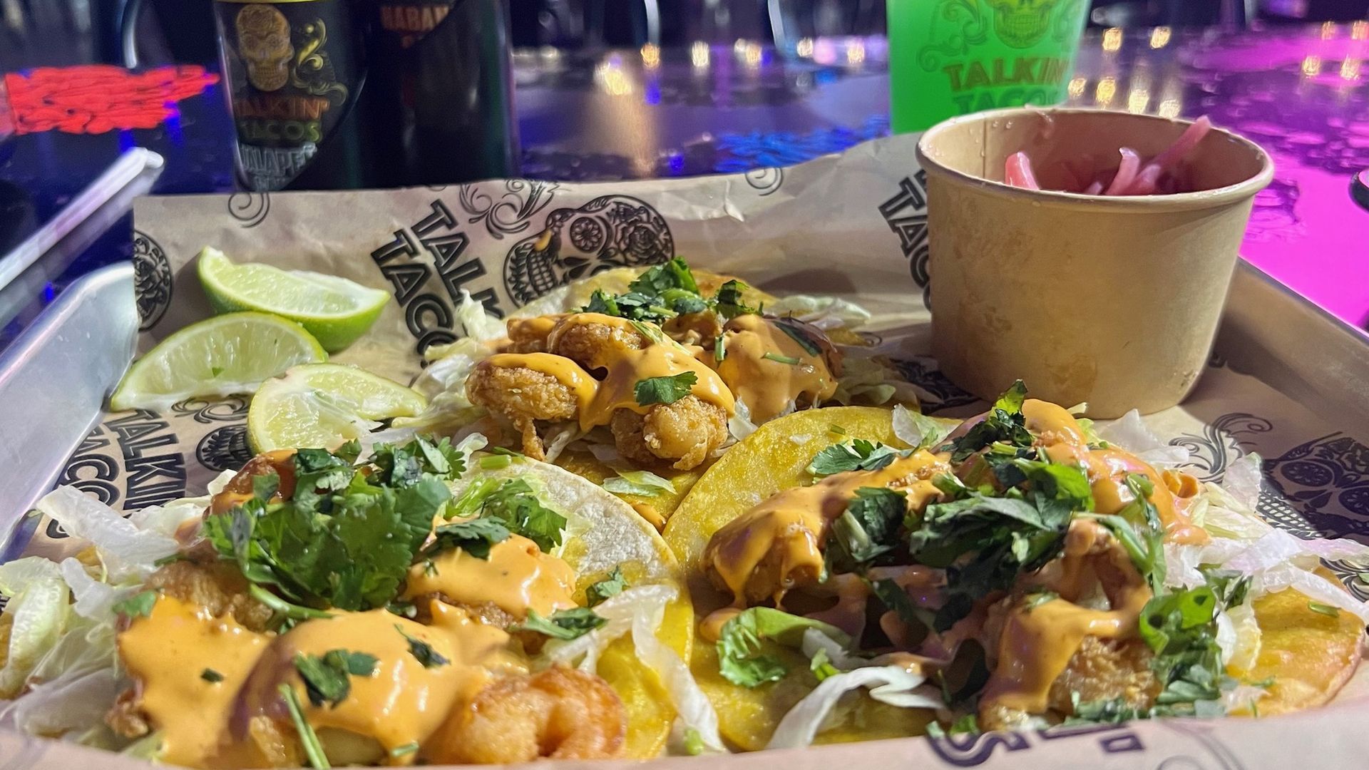 Three shrimp tacos on corn tortillas