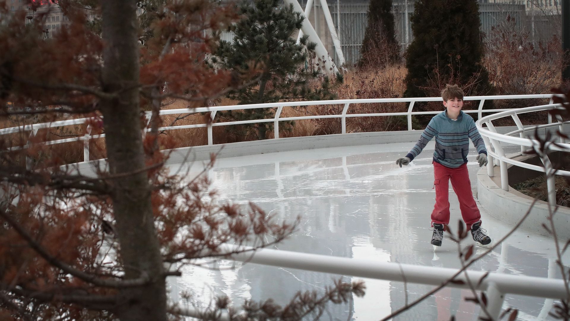 A boy skates on a skating rink. 