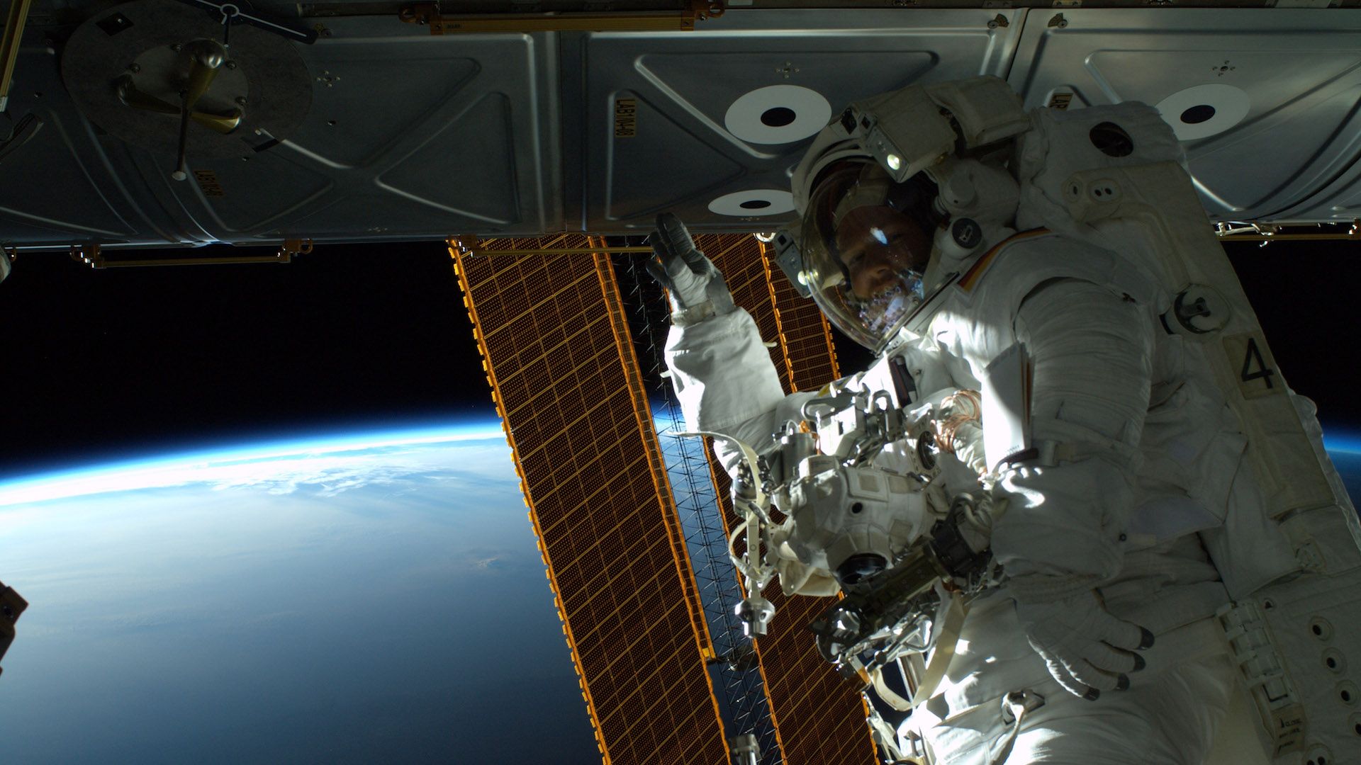 Astronaut conducting a spacewalk outside the space station.