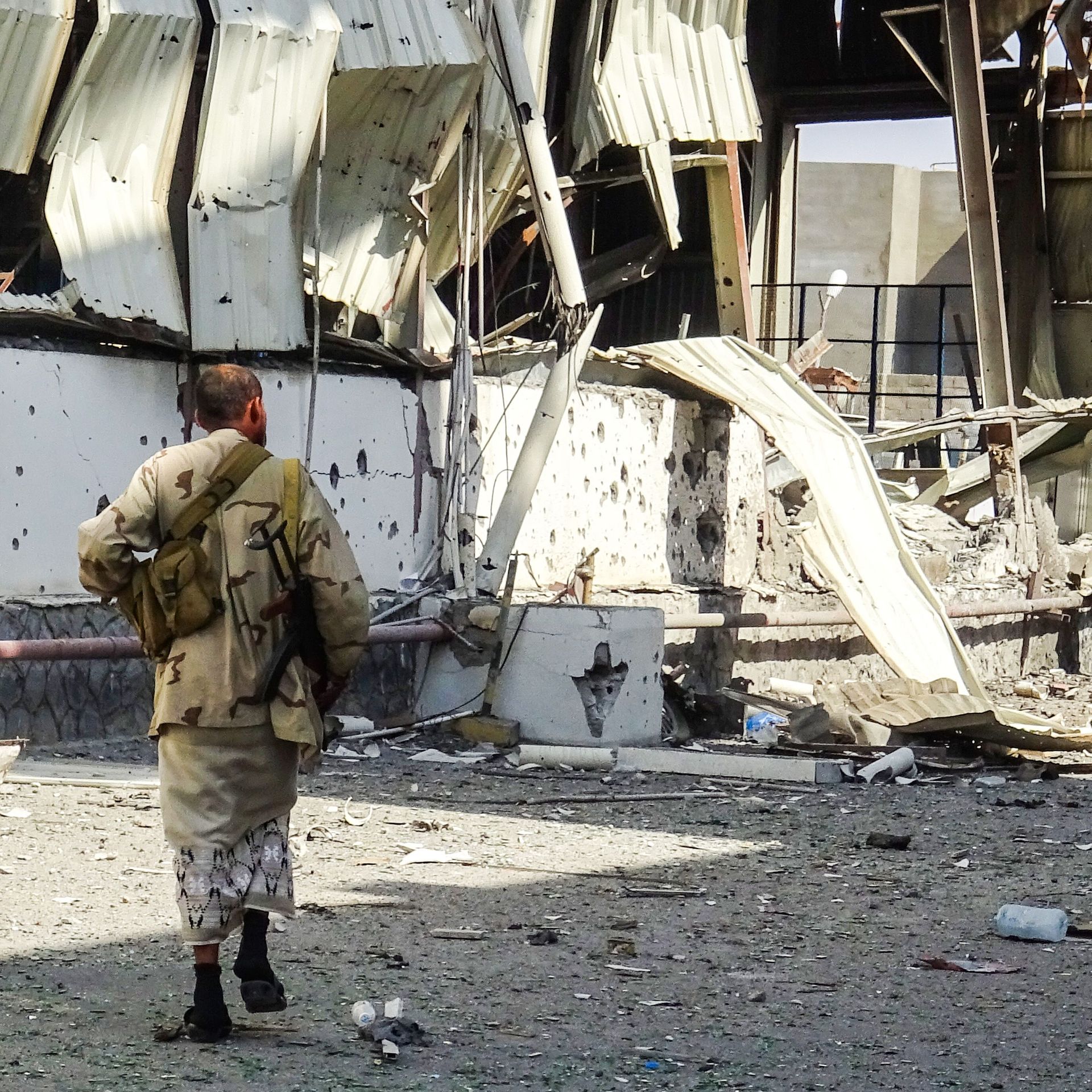 a soldier in a ravaged street of Hodeidah, Yemen