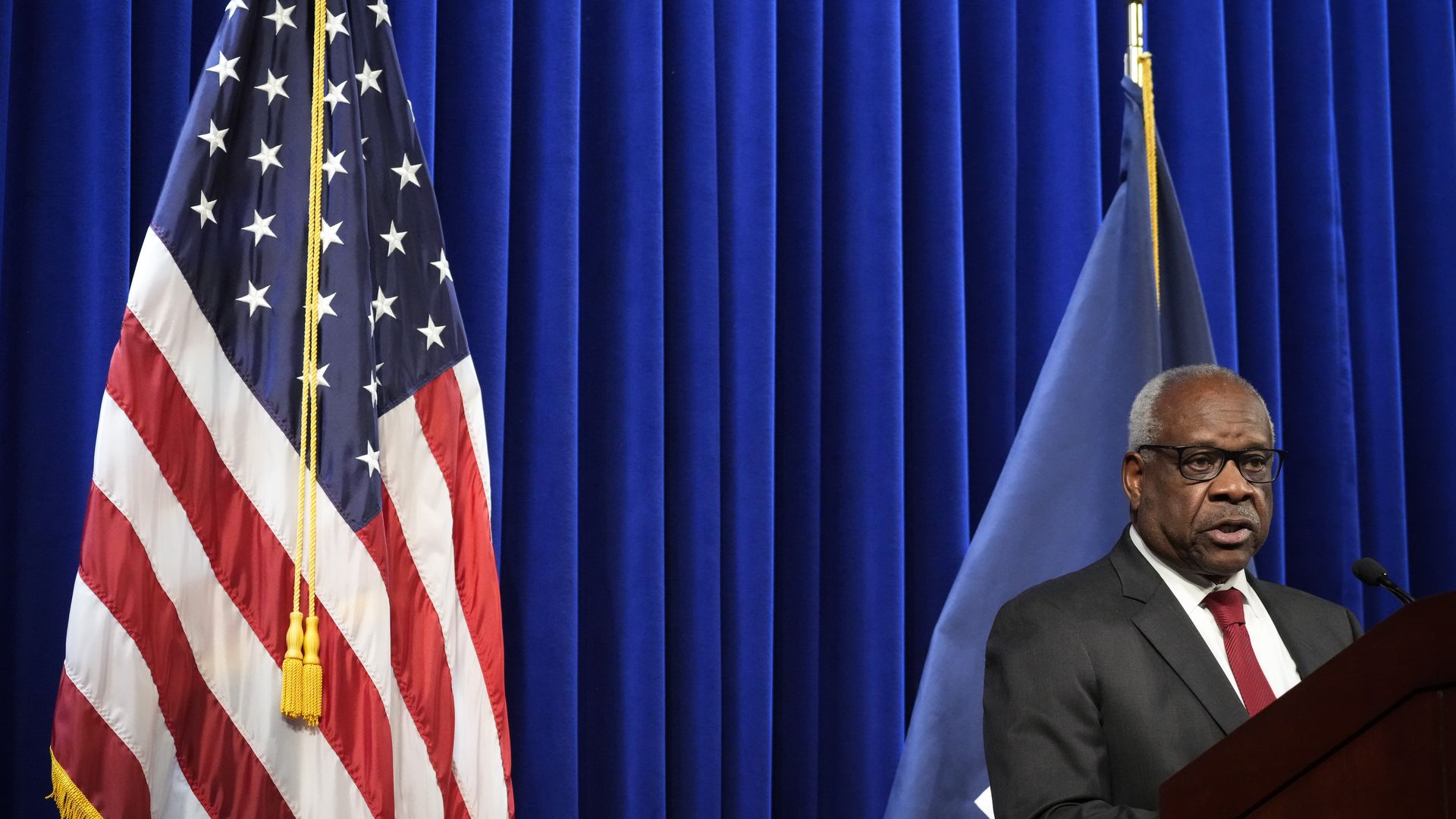 Photo of Clarence Thomas speaking from a podium
