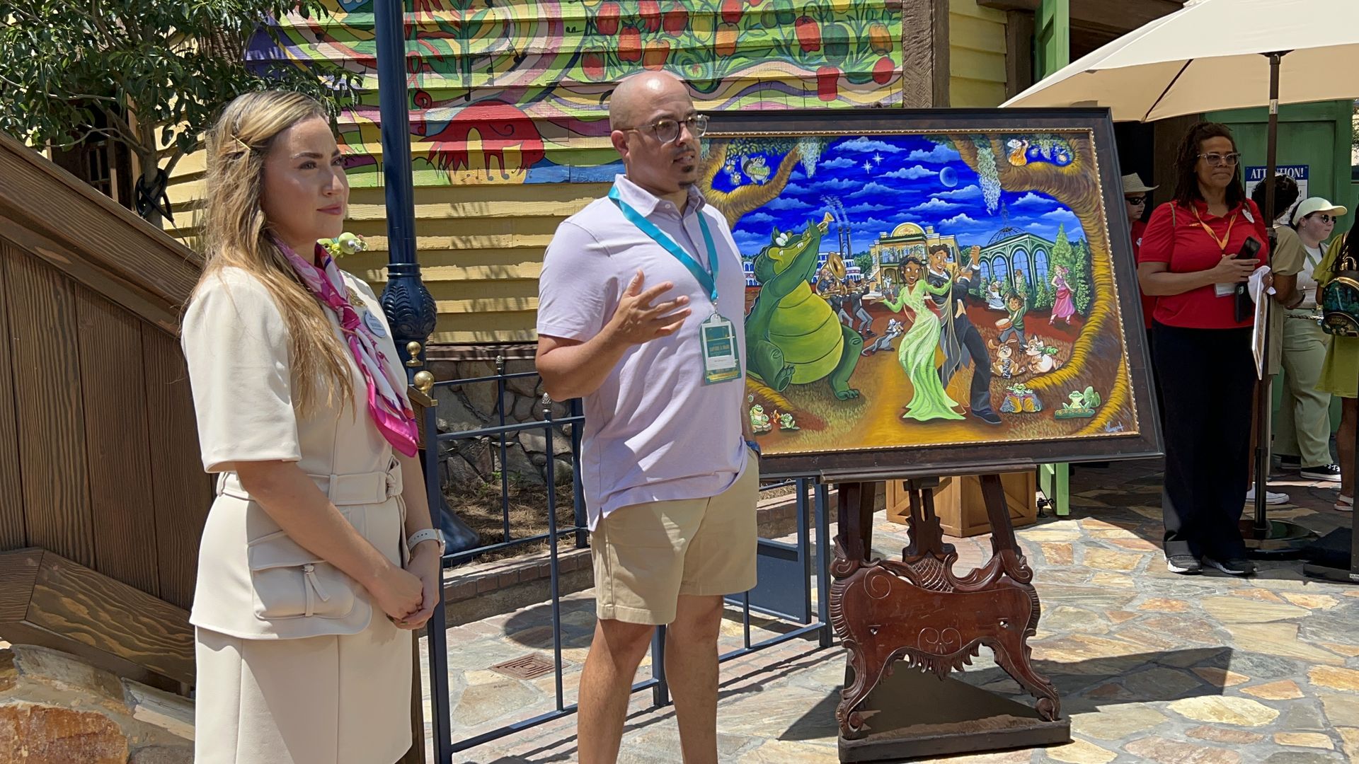 Painter Varion Laurent speaks in front of his Princess Tiana themed artwork.