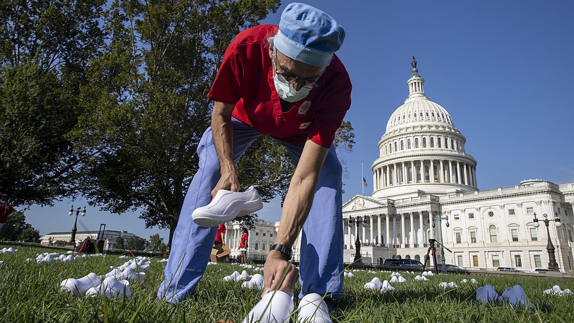 Scott Weinstein, Nurse at Washington Hospital places nurses shoes during a Vigil For Nurses Who've Died From Covid-19 at the U.S. Capital on July 21