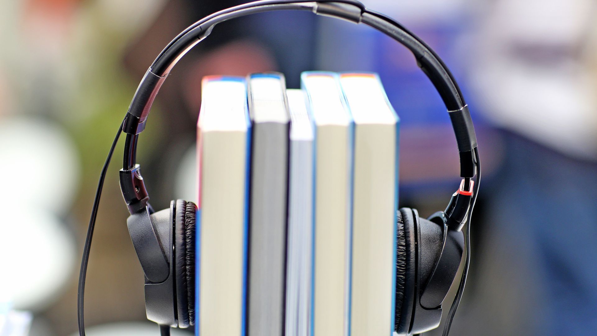 Books with headphones wrapped on them