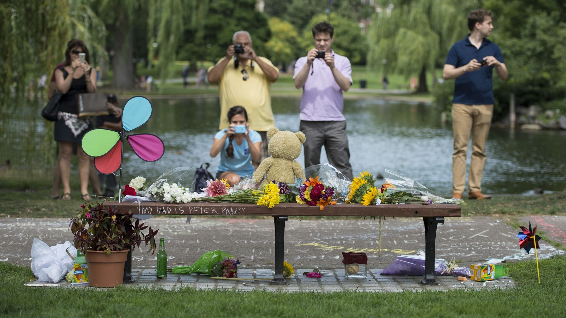 People take photos of a bench