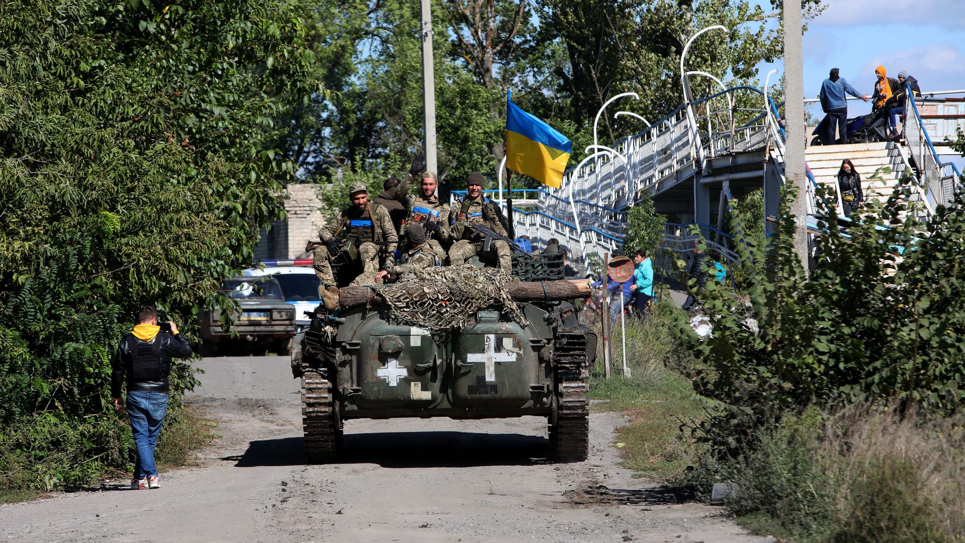 Ukrainian servicemen ride on top of a military vehicle in Izium on Sept. 19.