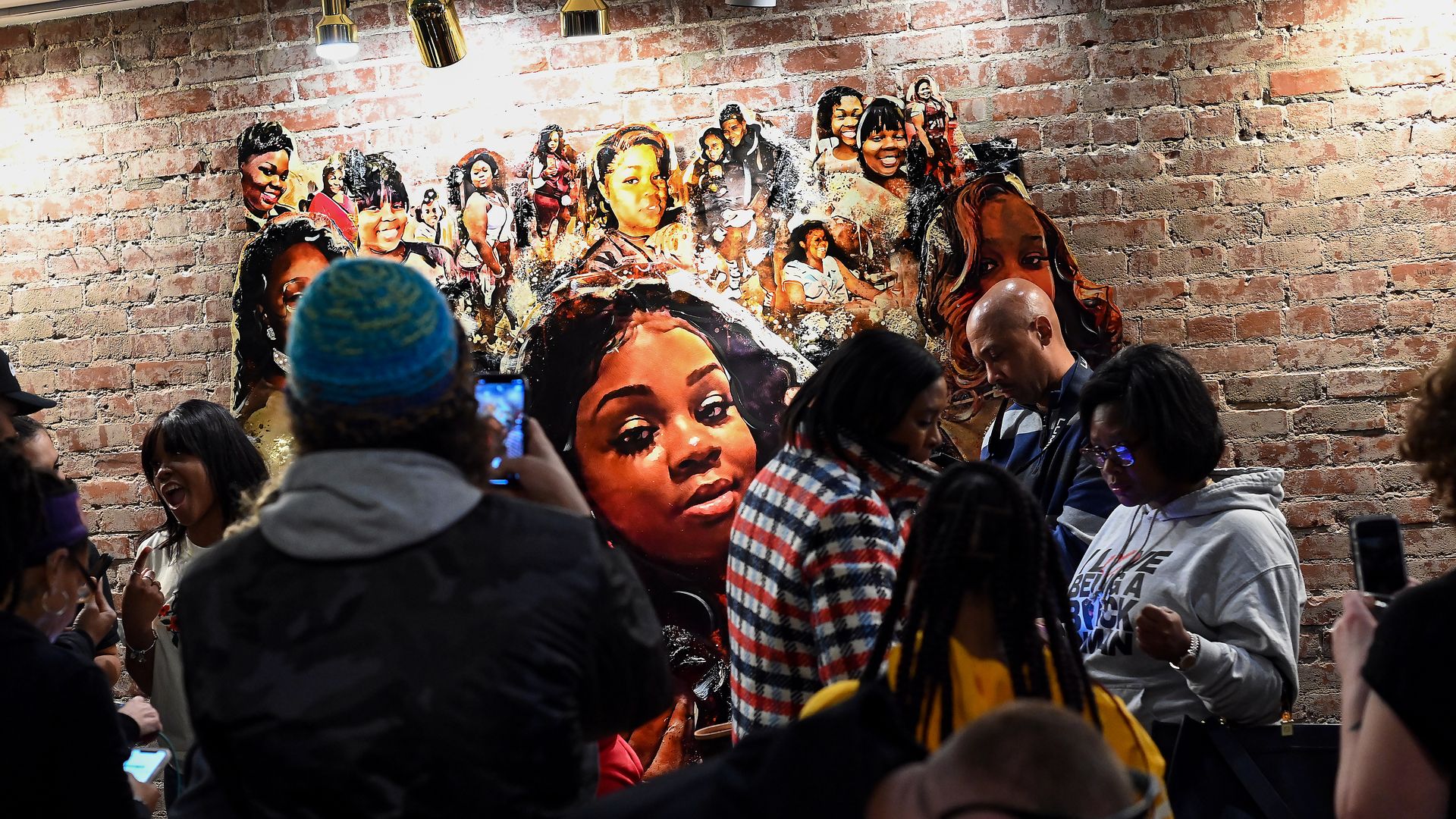 People gather at KULA Gallery during an unveiling of a Breonna Taylor painting on March12, 2022 in Louisville, Kentucky.