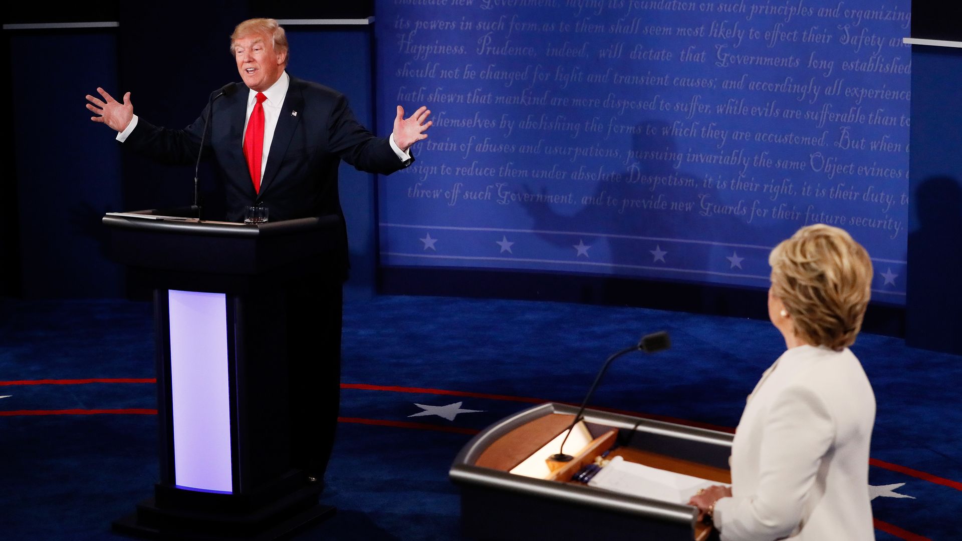 Republican presidential nominee Donald Trump (L) speaks as Democratic presidential nominee former Secretary of State Hillary Clinton