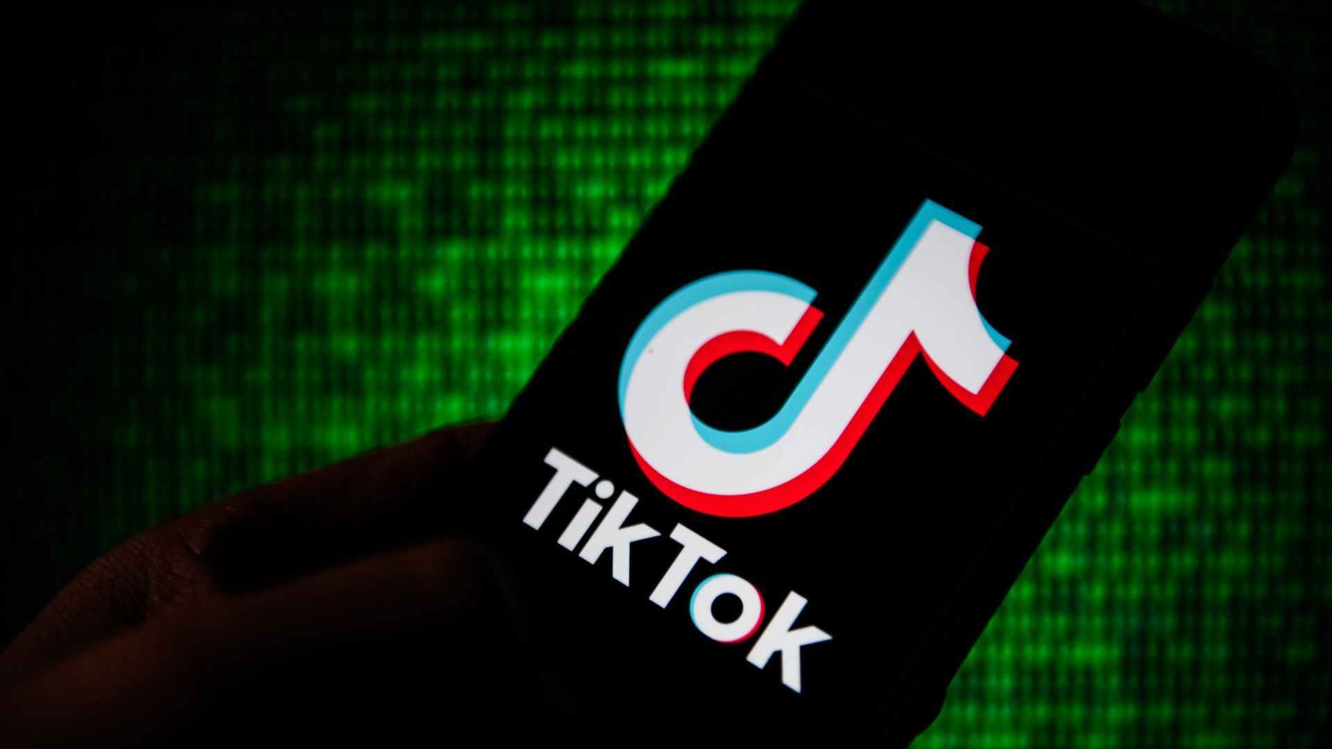 A photo illustration of a smartphone with a giant TikTok logo on it