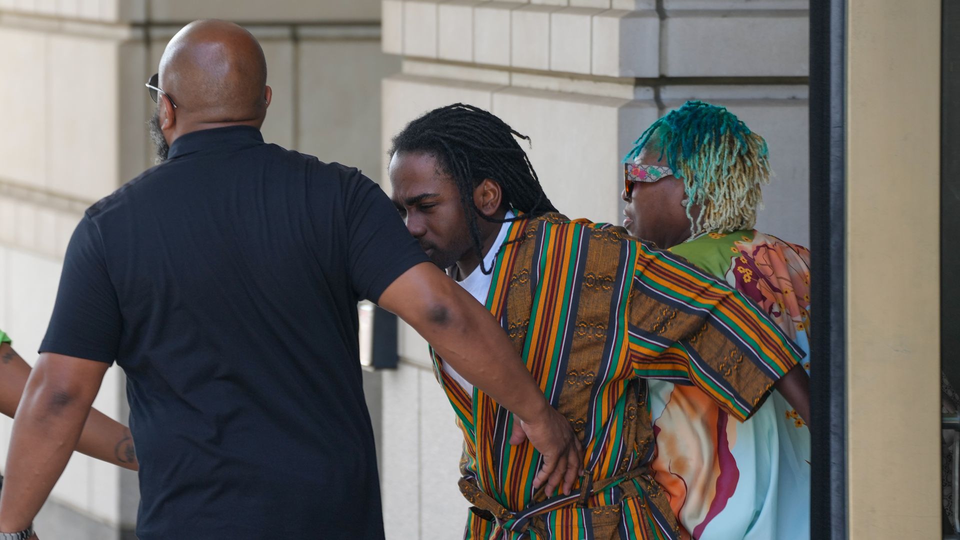 Trayon White exits courthouse with supporters flanking him