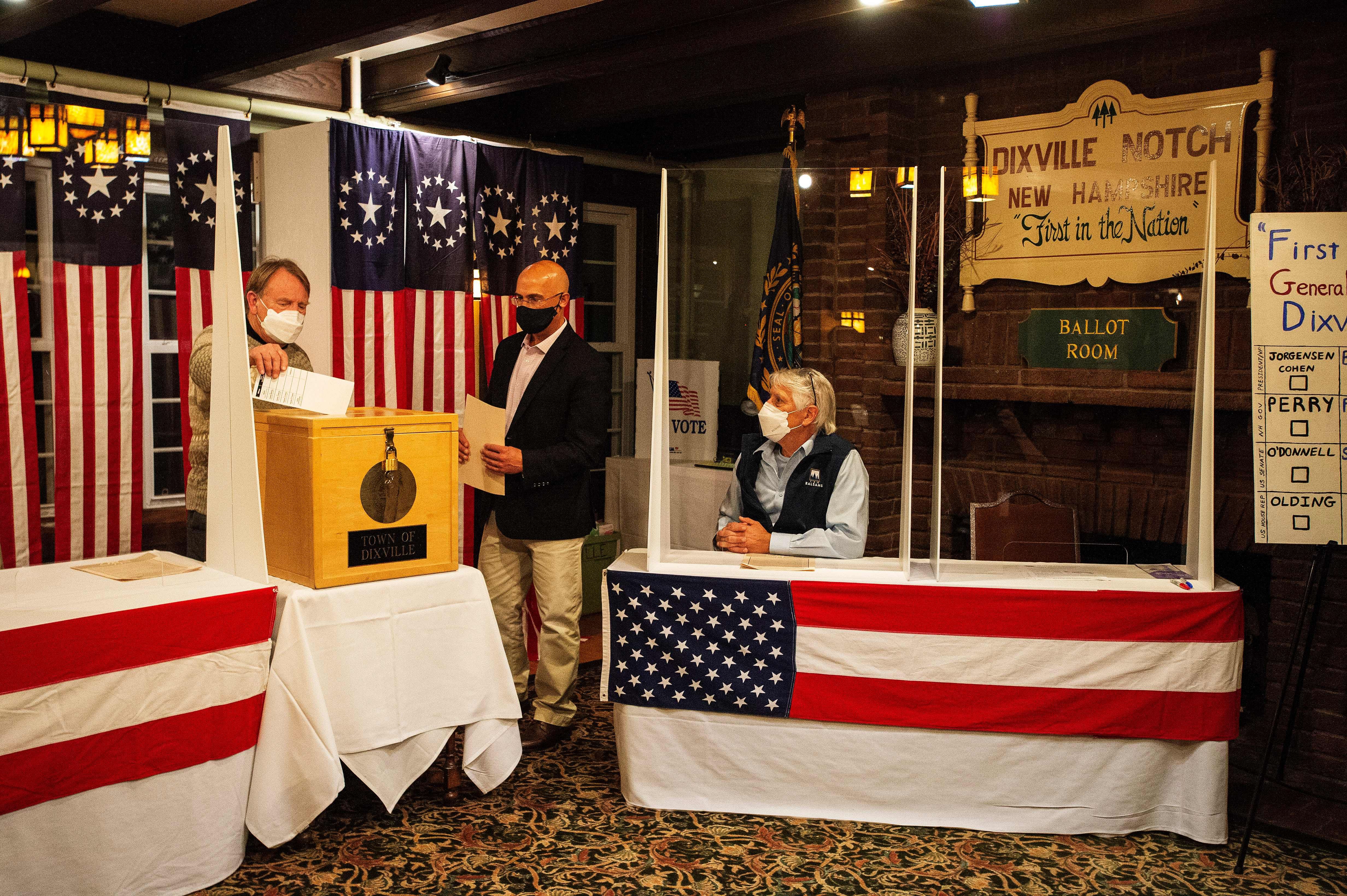 Tom Tillotson drops voters ballots into the ballot box at the Hale House at the historic Balsams Resort d