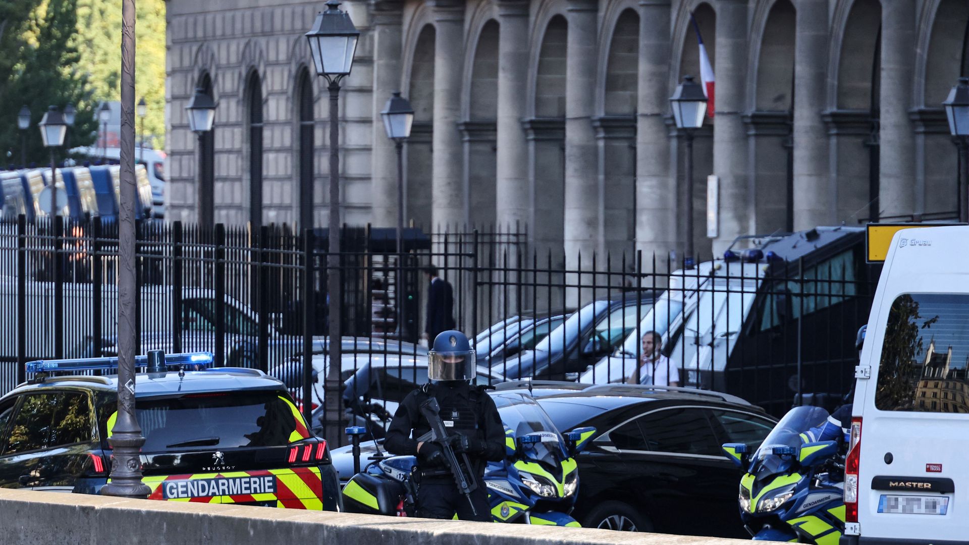 Picture of the Palais de Justice courthouse with French Gendarmes standing in front of the building